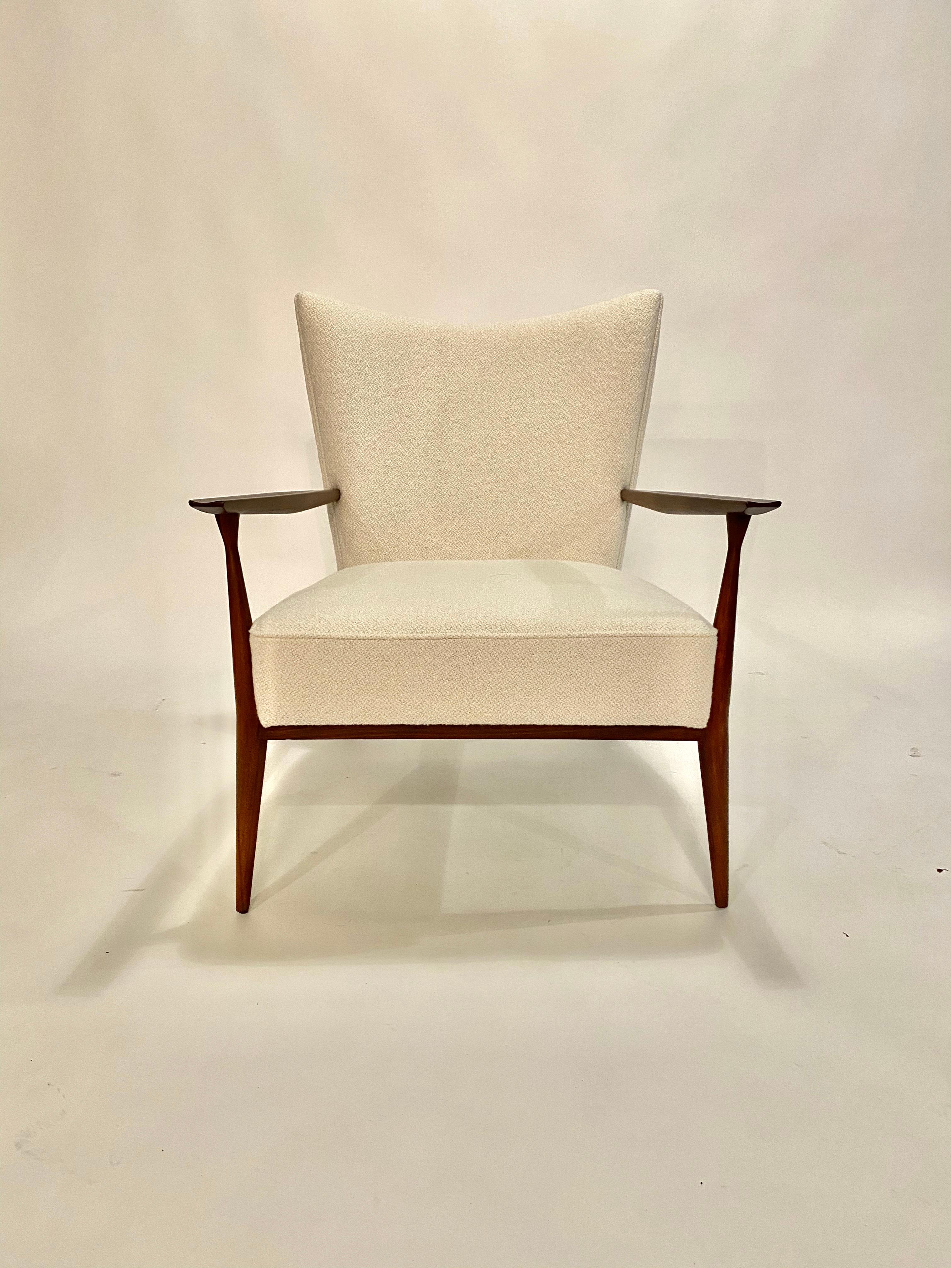 1950s Paul McCobb lounge chair in beautifully restored walnut and reupholstered in an Italian ivory bouclé. This chair is stunning at every angle.