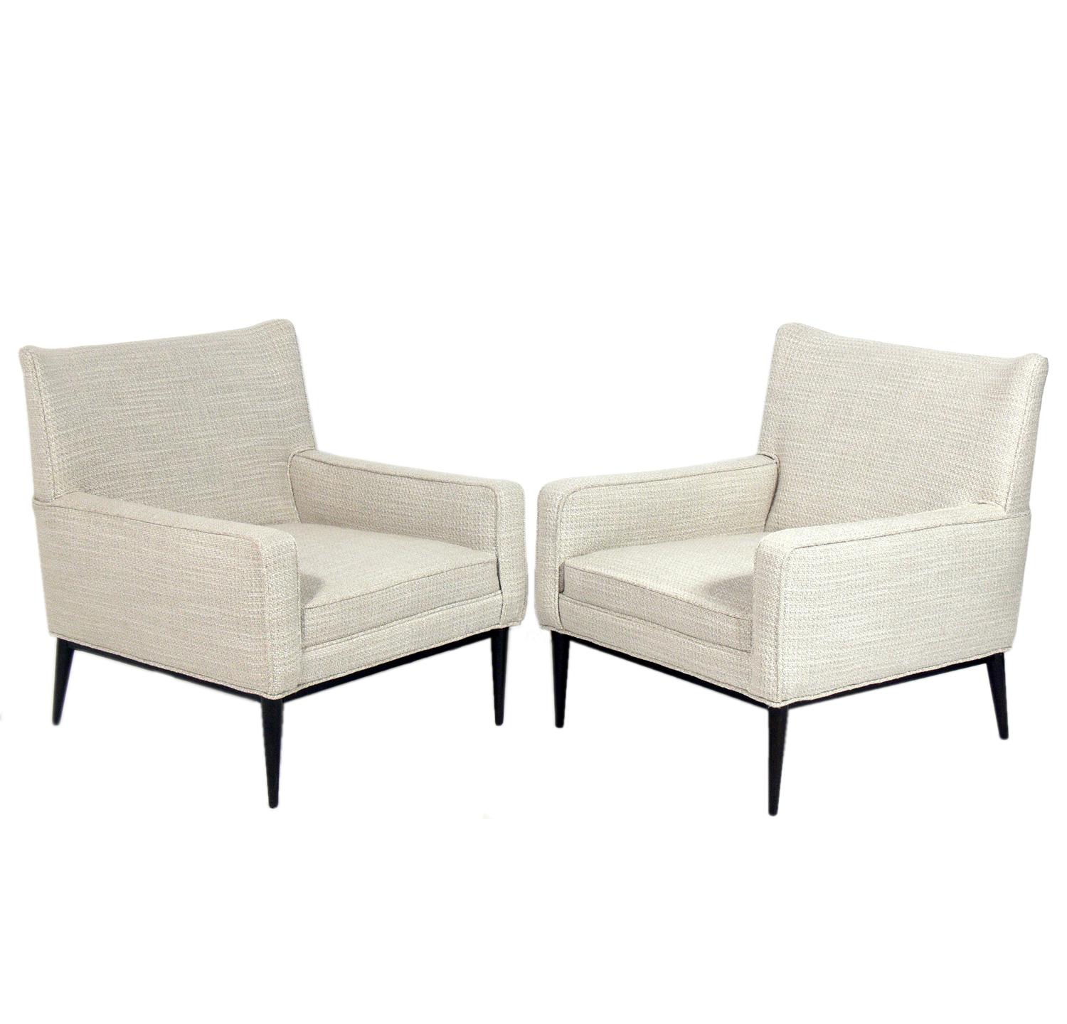 Pair of Curvaceous Lounge Chairs and Ottoman, designed by Paul McCobb for Directional, American, circa 1950s. They have been reupholstered in a sand and ivory colored textured fabric and the legs have been refinished in an ultra deep brown color.