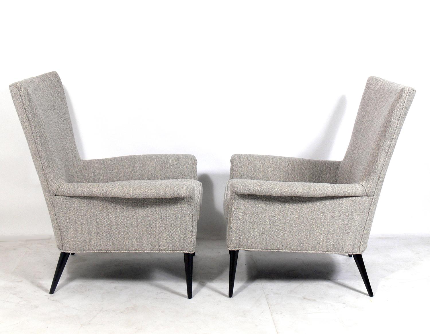 Pair of curvaceous lounge chairs, designed by Paul McCobb for Custom Craft, American, circa 1950s. They have been reupholstered in a grey and ivory textured fabric and the legs have been refinished in an ultra-deep brown color.