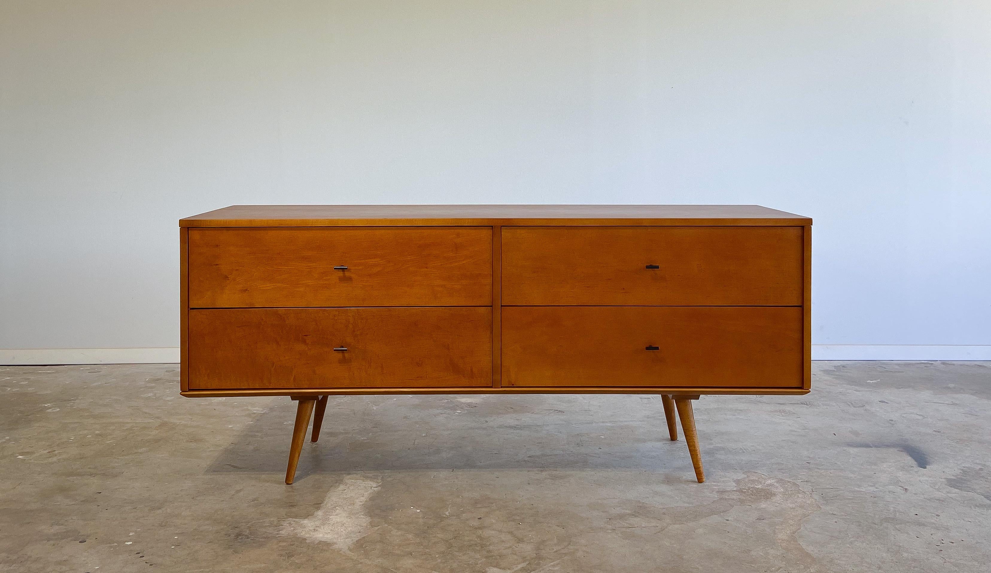Offered is a rare low credenza or dresser designed by Paul McCobb for Winchendon Furniture. 

Featuring a solid maple four drawer chest (model 1504) that sits on top of a solid maple bench (model 1546). The Planner Group line was intended to be