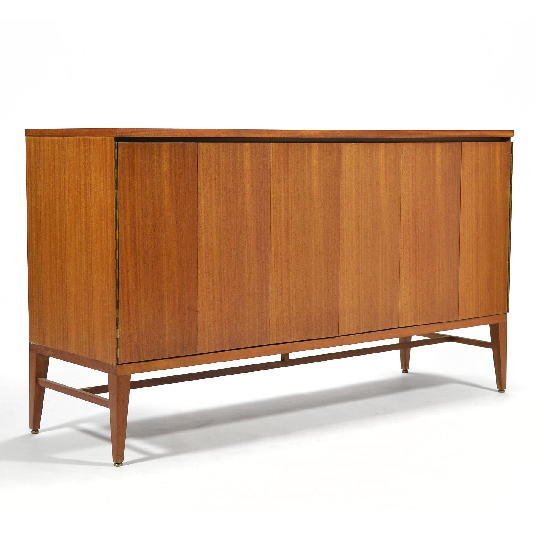 Beautiful mahogany credenza by Paul McCobb for Calvin. Two sets of tri-fold doors conceal two adjustable shelves and a bank of drawers.

33.5