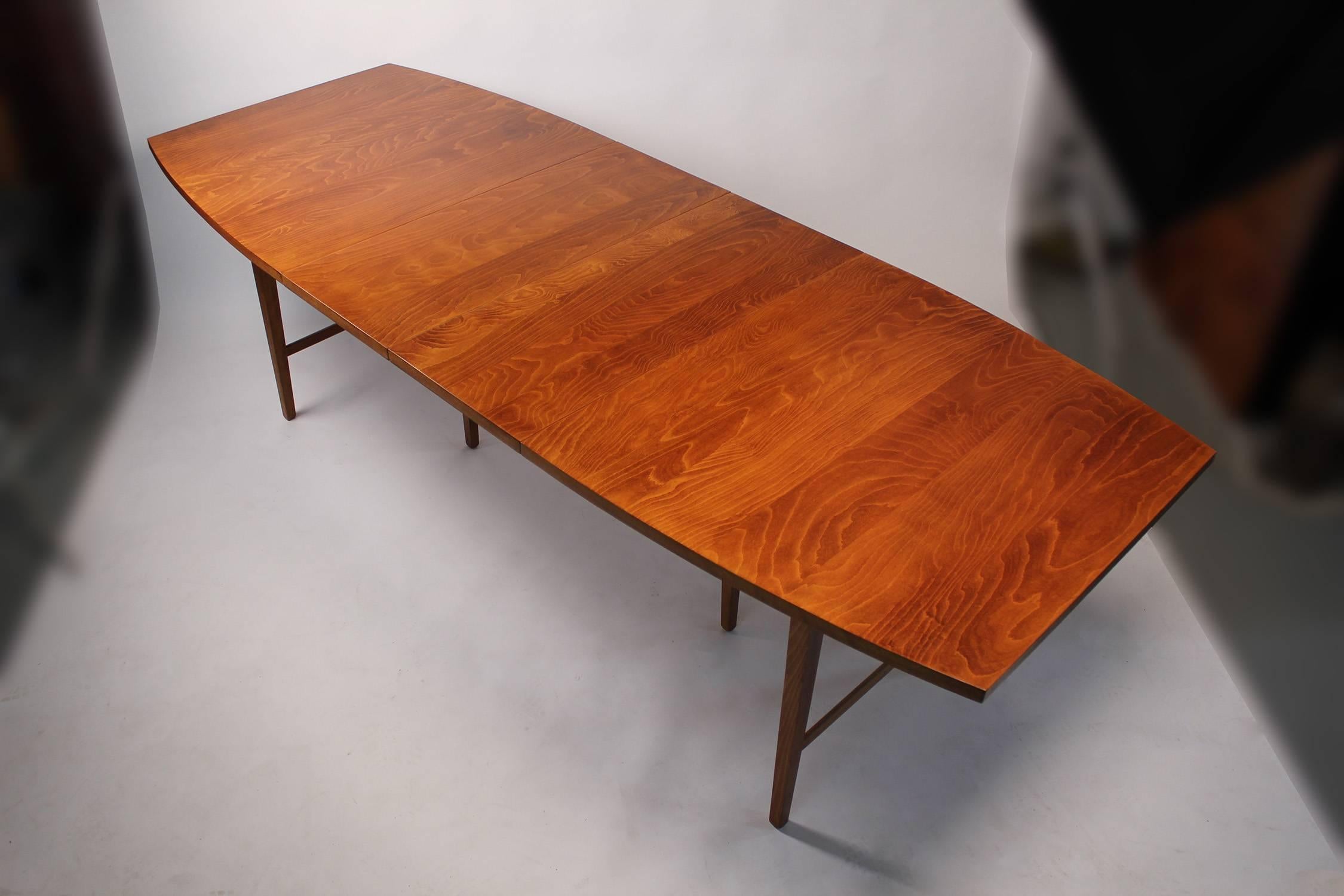 1960s Paul McCobb designed perimeter group dining table with two leaves. The maple top is absolutely incredible on this piece. The striations in the wood grain are very exotic. When both leaves are in place the table measures 96