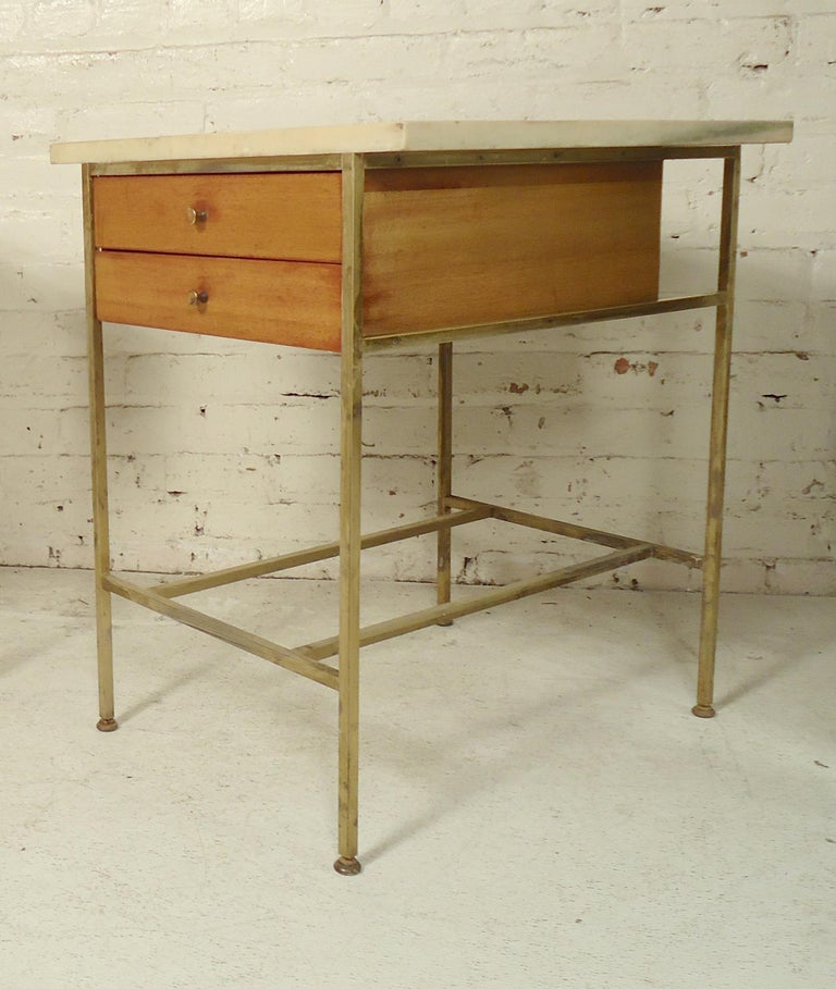 Pair of Mid-Century Modern end tables by Paul McCobb for his Irwin collection. Mahogany wood with two drawers and brass frames with matching knobs. Thick marble tops on both tables.

(Please confirm item location - NY or NJ - with dealer).
   
