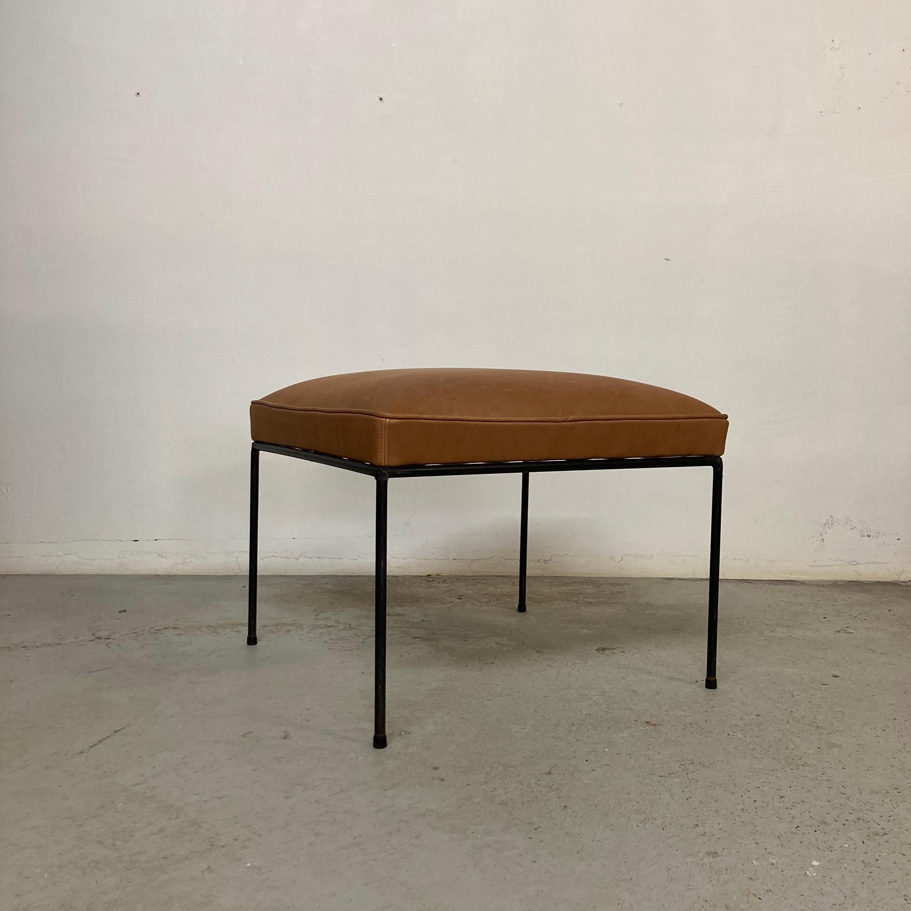 Mid-Century Modern iron stool by Paul McCobb.

Newly reupholstered as they originally were, with no-sag springs, foam and a thick brown leather.

Original condition for the iron feet with light surface rust on some parts.