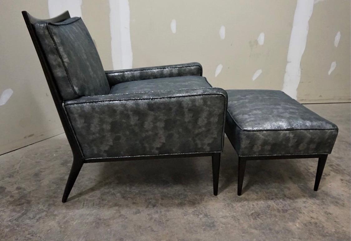 Iconic Paul McCobb model 1322 lounge chair and matching ottoman. The frame has a dark brown
finish and pencil point legs. It is rare to find a 1322 chair with the matching ottoman. The upholstery
is a faux leather in black and silver grain.