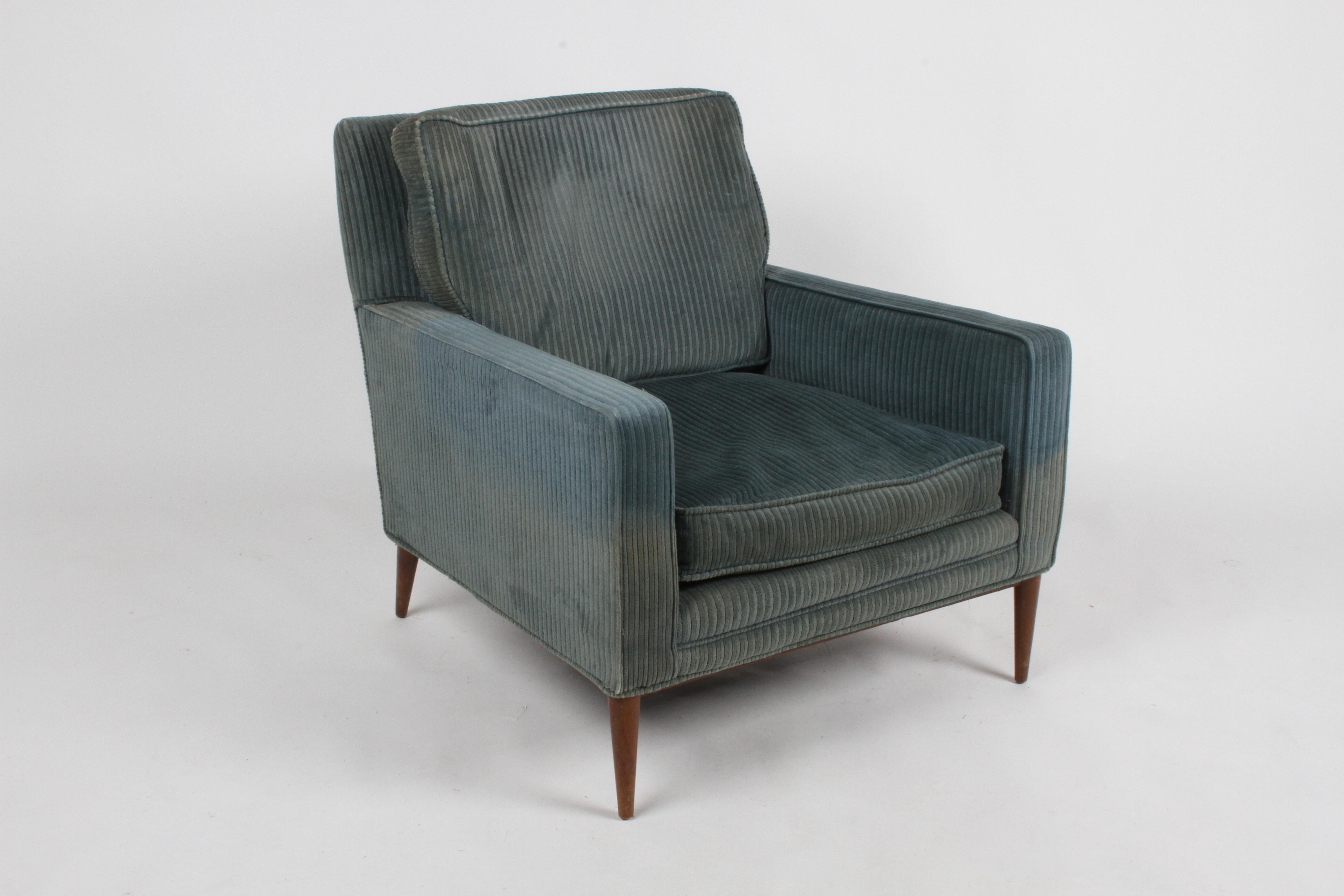 Paul McCobb Mid-Century Modern lounge chair for his Directional line with original walnut finish to maple frame on tapered legs. Older corduroy re-upholstery, upholstery and foam need updating. Front is wider than back, tapers from 30.75