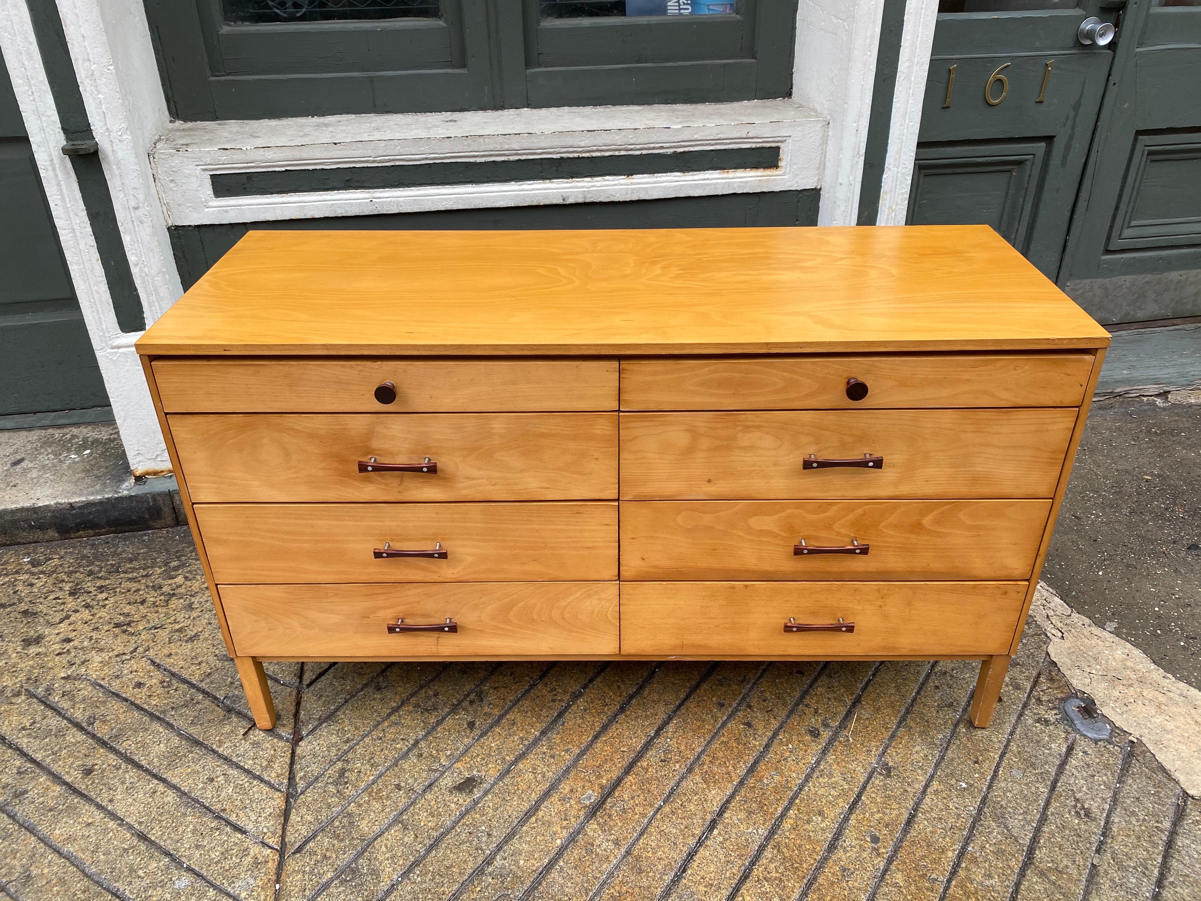 Paul McCobb perimeter group 8-drawer dresser for Winchendon Furniture. Maple outer body and drawer fronts with rosewood handles. All original, showing some overall wear, and small area of veneer loss to right side as seen in photos. Retains original