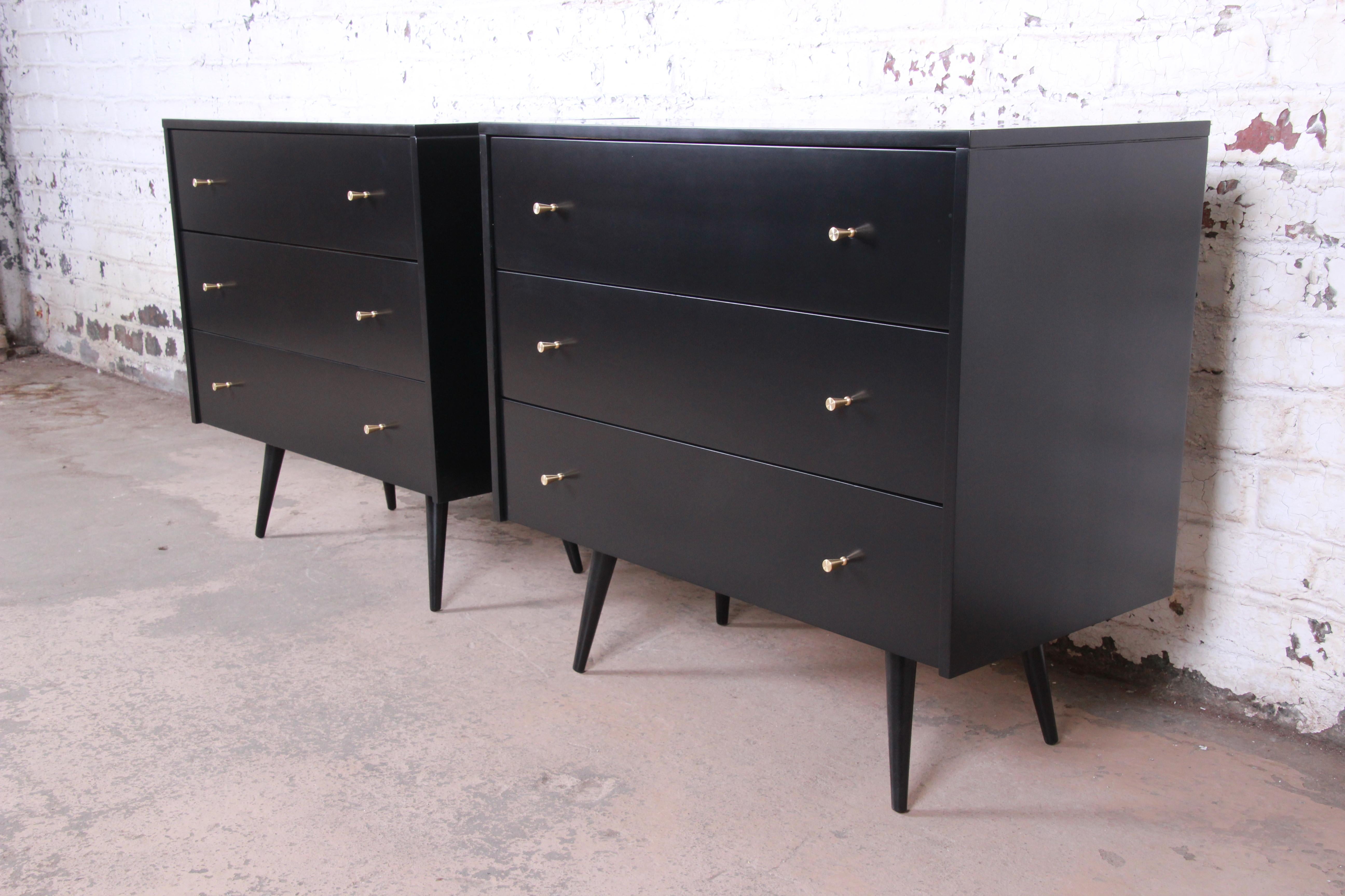 An outstanding pair of Mid-Century Modern bachelor chests or large nightstands designed by Paul McCobb for his planner group line for Winchendon Furniture. The chests feature solid maple construction with a beautiful black lacquered finish and
