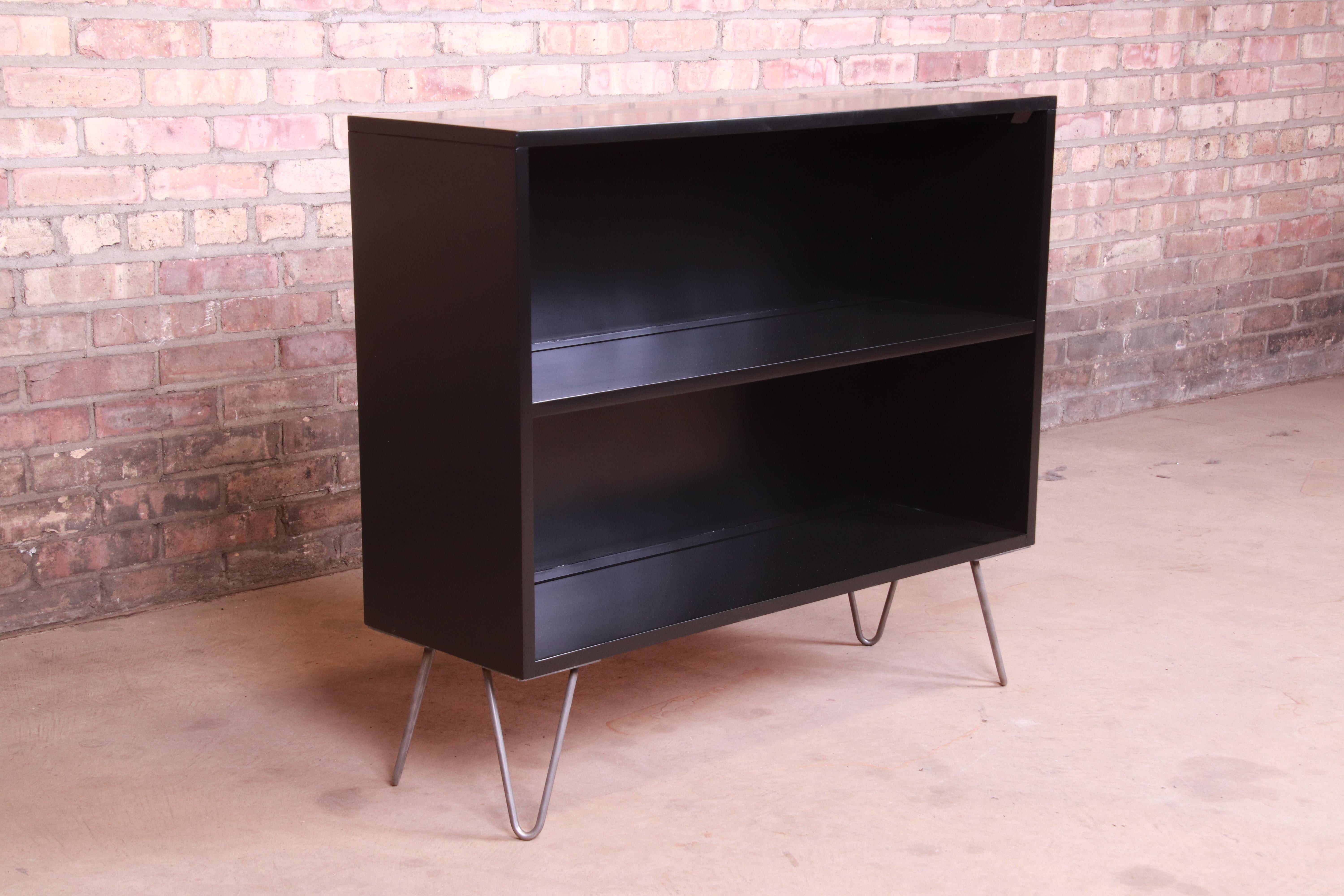 An exceptional Mid-Century Modern black lacquered solid birch bookcase on hairpin legs

By Paul McCobb for Winchendon Furniture 