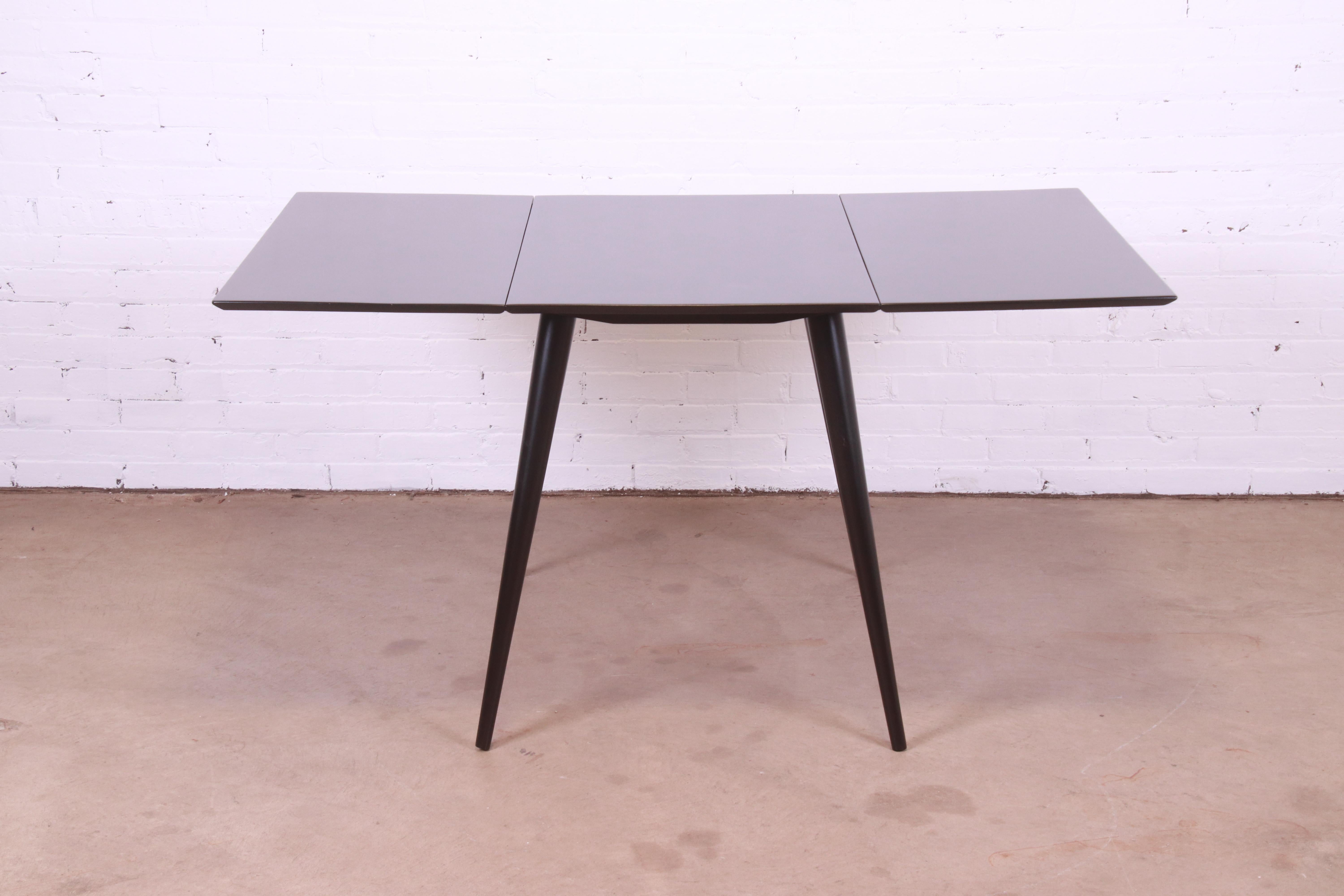 An exceptional Mid-Century Modern black lacquered solid maple drop-leaf dining table

By Paul McCobb for Winchendon Furniture, 