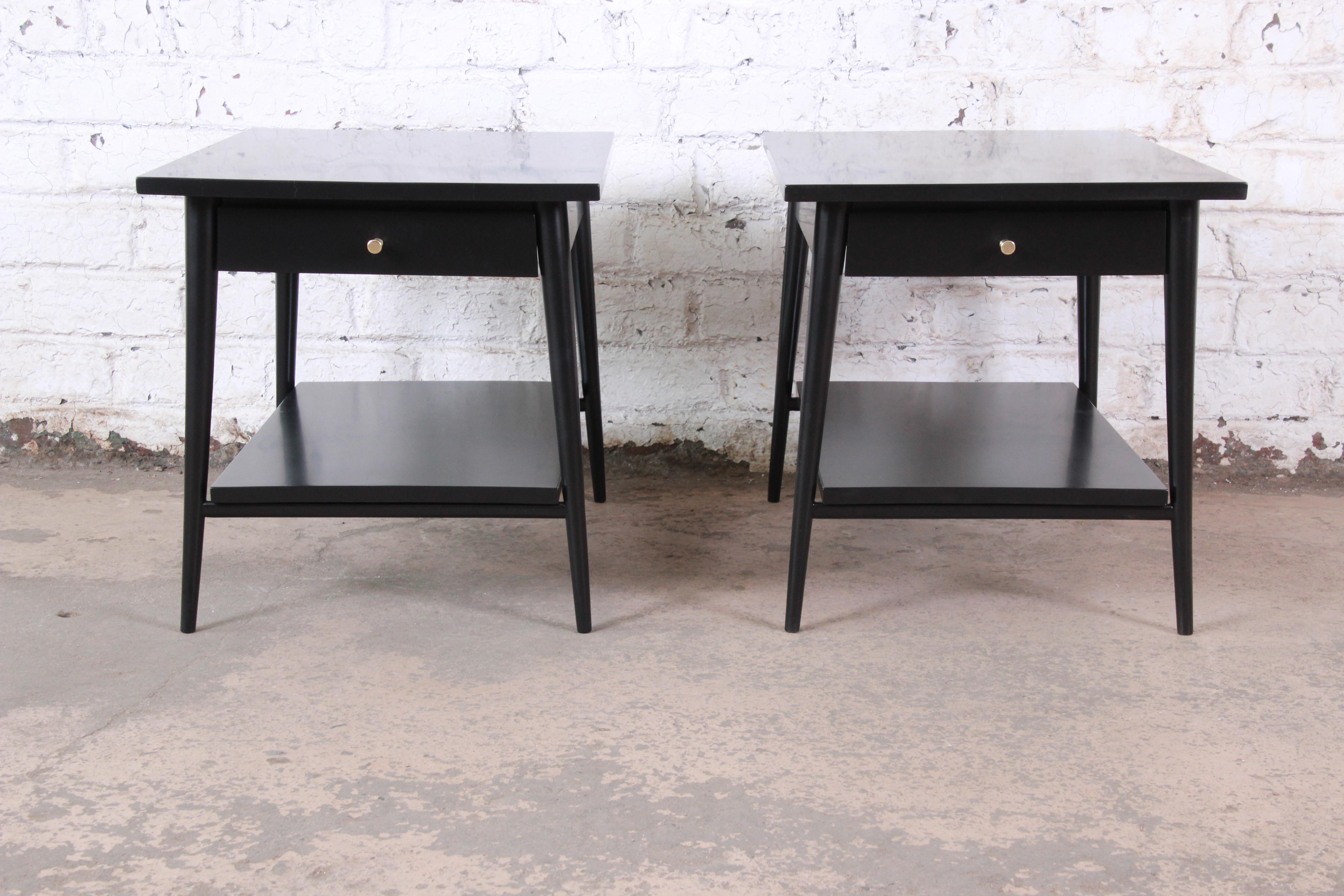 An exceptional pair of Mid-Century Modern black lacquered nightstands or end tables

Designed by Paul McCobb for his planner group line for Winchendon Furniture

USA, 1950s

Solid birch and black lacquer and brass

Measures: 19.25