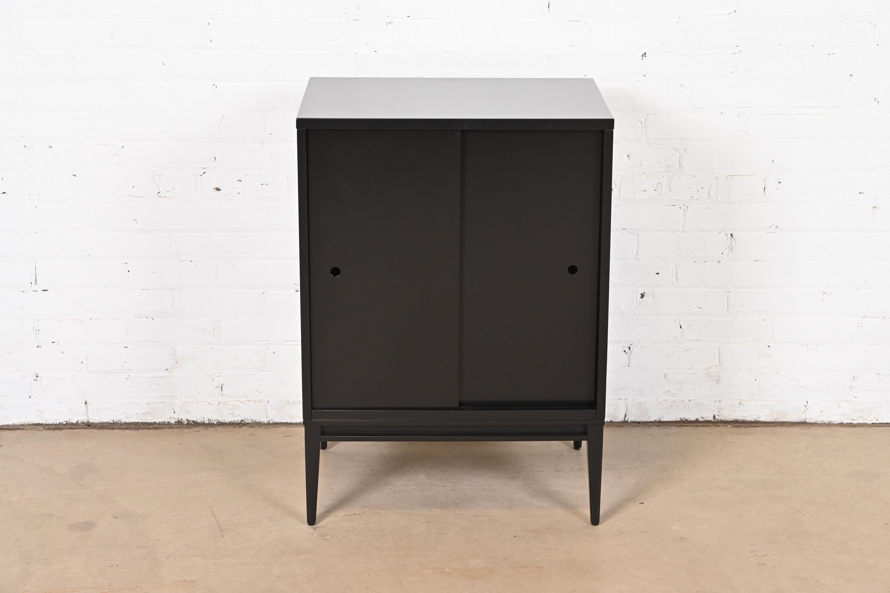 A gorgeous Mid-Century Modern black lacquered solid maple record cabinet or bar cabinet with sliding doors

By Paul McCobb for Winchendon Furniture, 