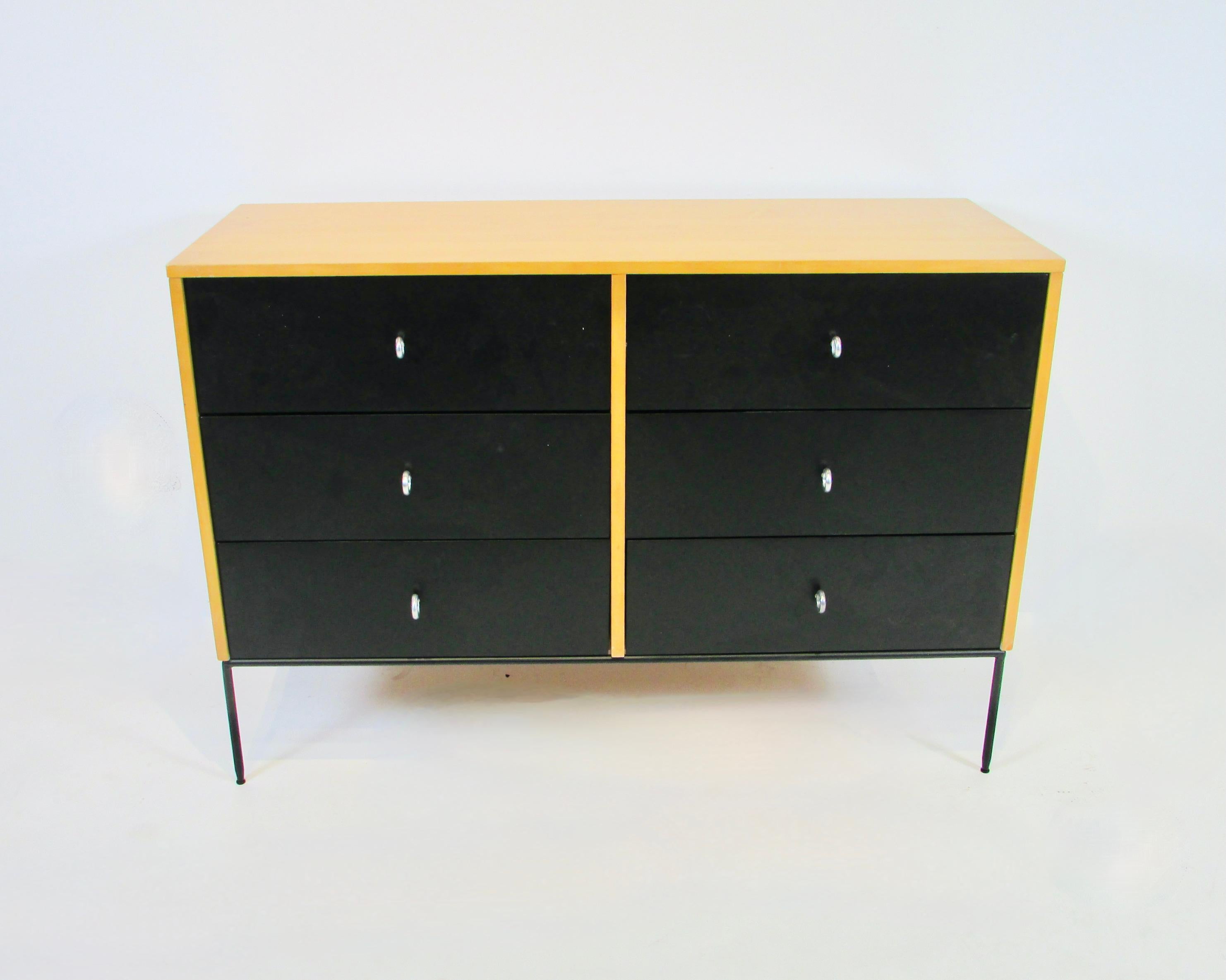 Master of mid-century American modular design Paul McCobb for Winchedon Planner group six drawer dresser. Maple case holds black lacquered drawers. All supported by the early production wrought iron base. Drawers have Winchedon aluminum ring pulls.