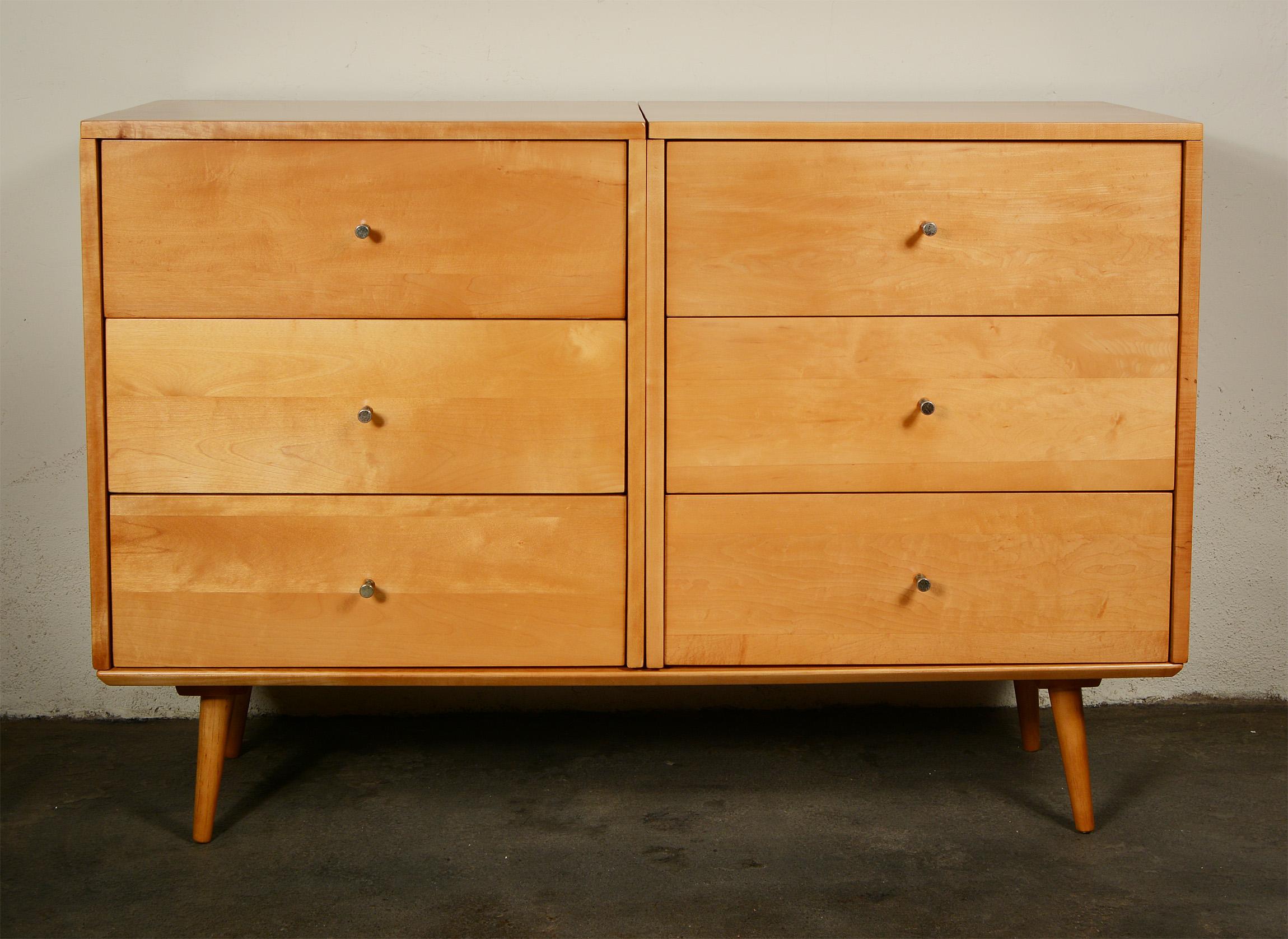 Two three-drawer chests resting on a low bench designed by Paul McCobb as part of the Planner Group. This set has been refinished. The handles have lost some of their brass plating.