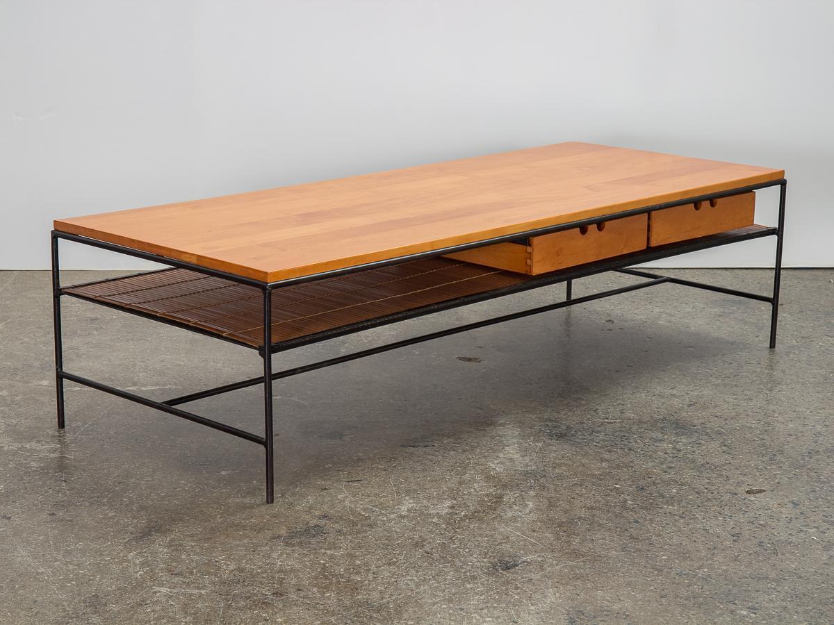 Early Planner Group coffee table with drawers, designed by Paul McCobb for Winchendon Furniture. Large and sturdy table with an ample surface, made from pretty solid maple. Functional storage is added in two drawers and a charming woven bamboo shelf