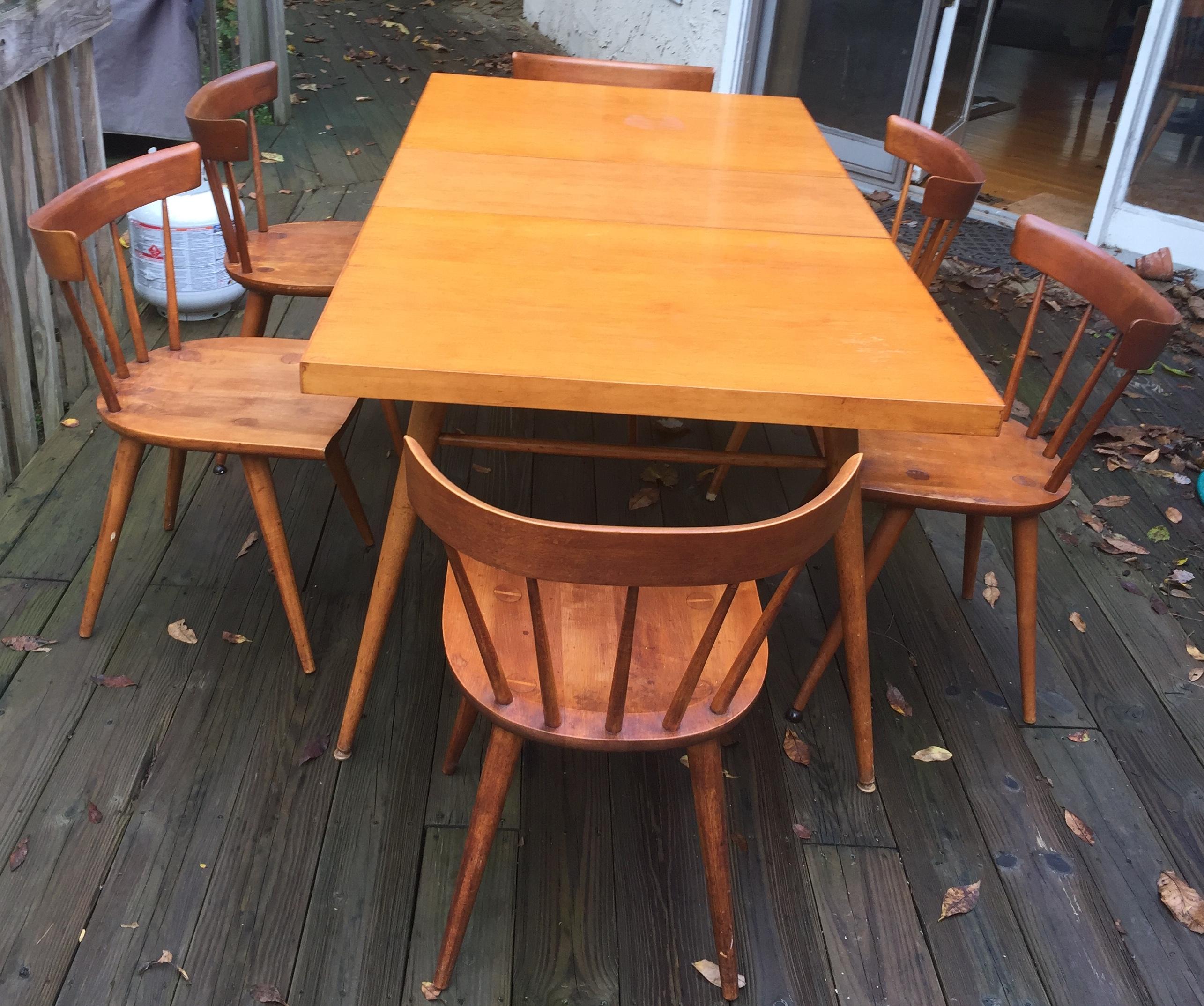 Handsome solid maple dining table with two leaves and six spindleback chairs made for the Winchendon Furniture Company. The table without leaves is 60”, and expands to a total of 84” (12” w leaves), comfortably accommodating 8 place settings. This