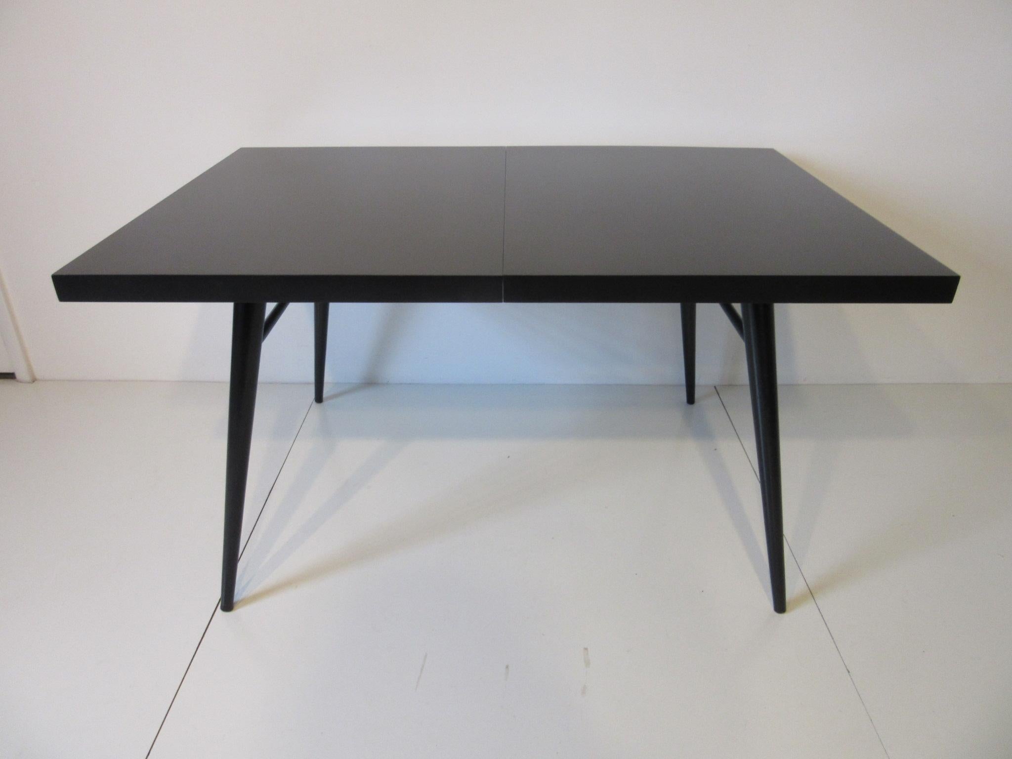 A original satin black restored McCobb dining table with two slip in 15
