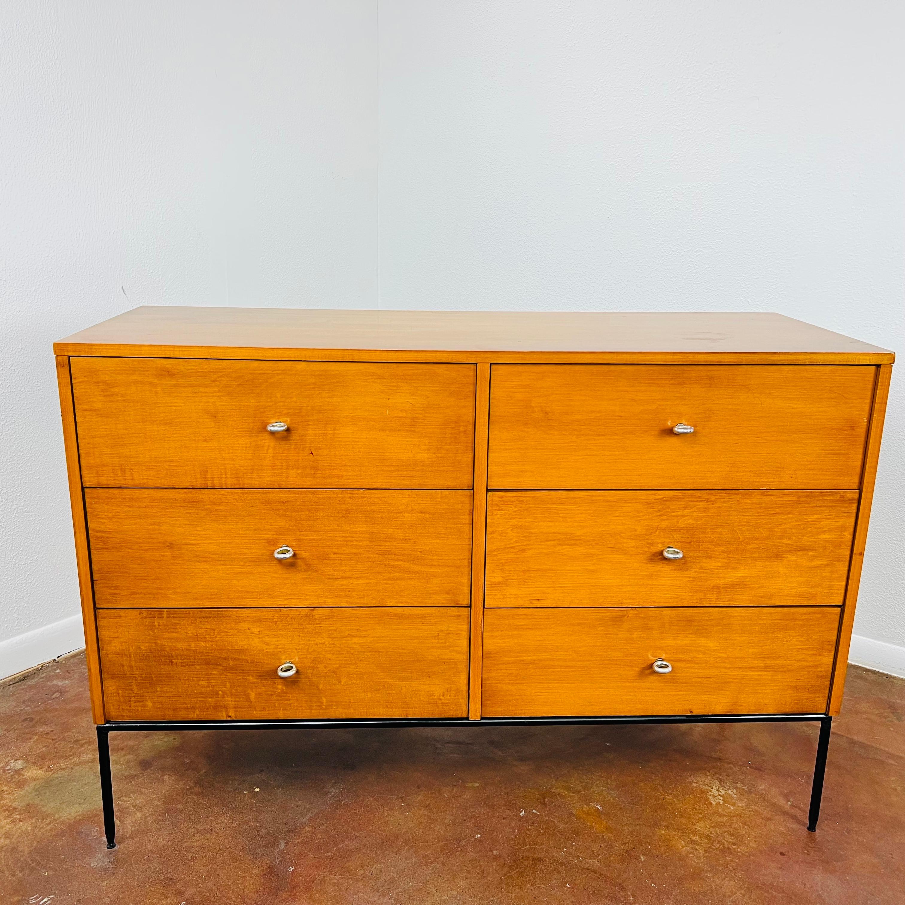 Timeless mid-century modern 6 drawer dresser designed by Paul McCobb for Winchendon Furniture, circa 1950s. Maple wood construction sits on a black iron base and is stamped on interior of drawer with the designer and manufacturer signatures.