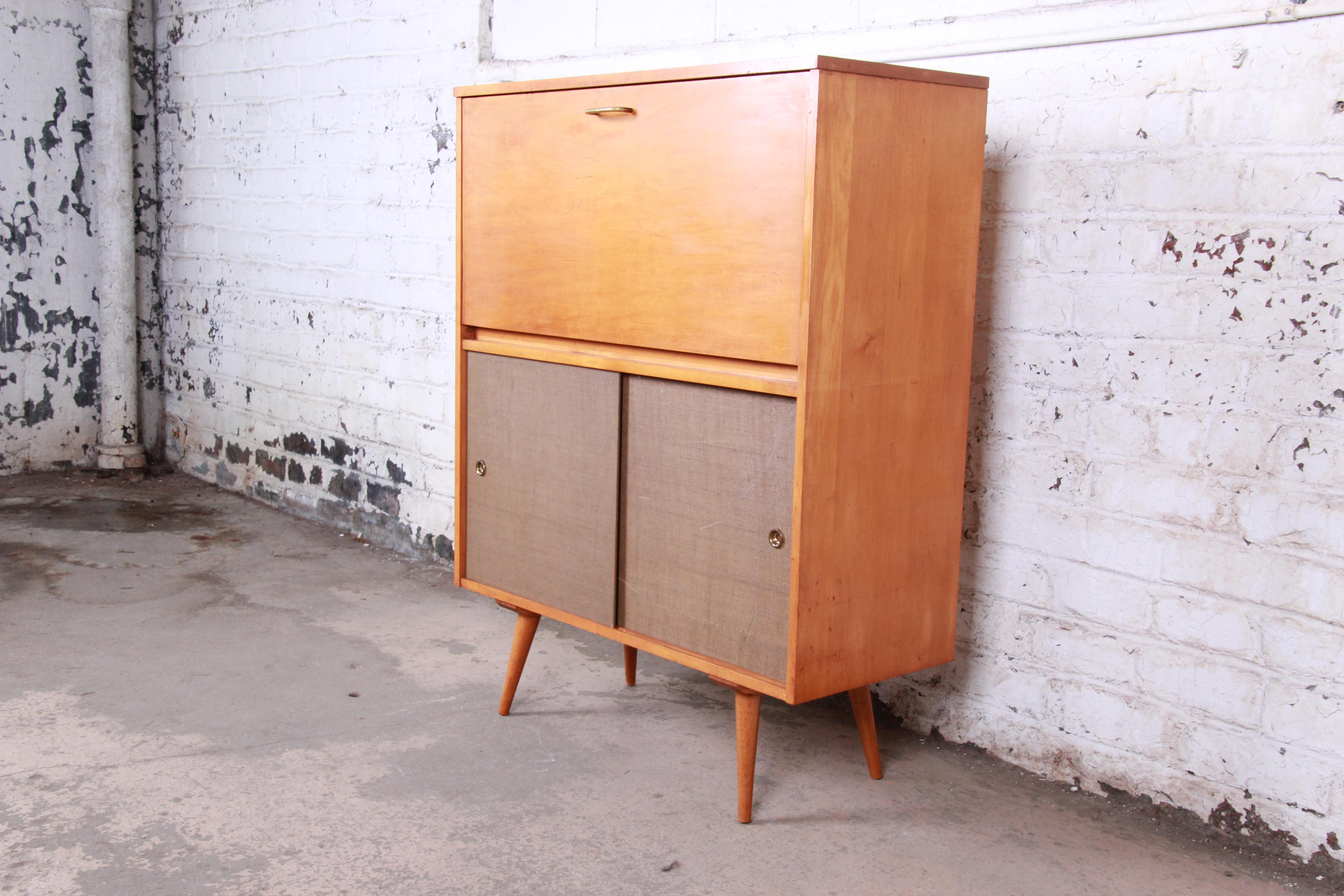 A rare and exceptional Mid-Century Modern drop front storage cabinet or secretary desk with a lower sliding door credenza

By Paul McCobb for Winchendon Furniture 