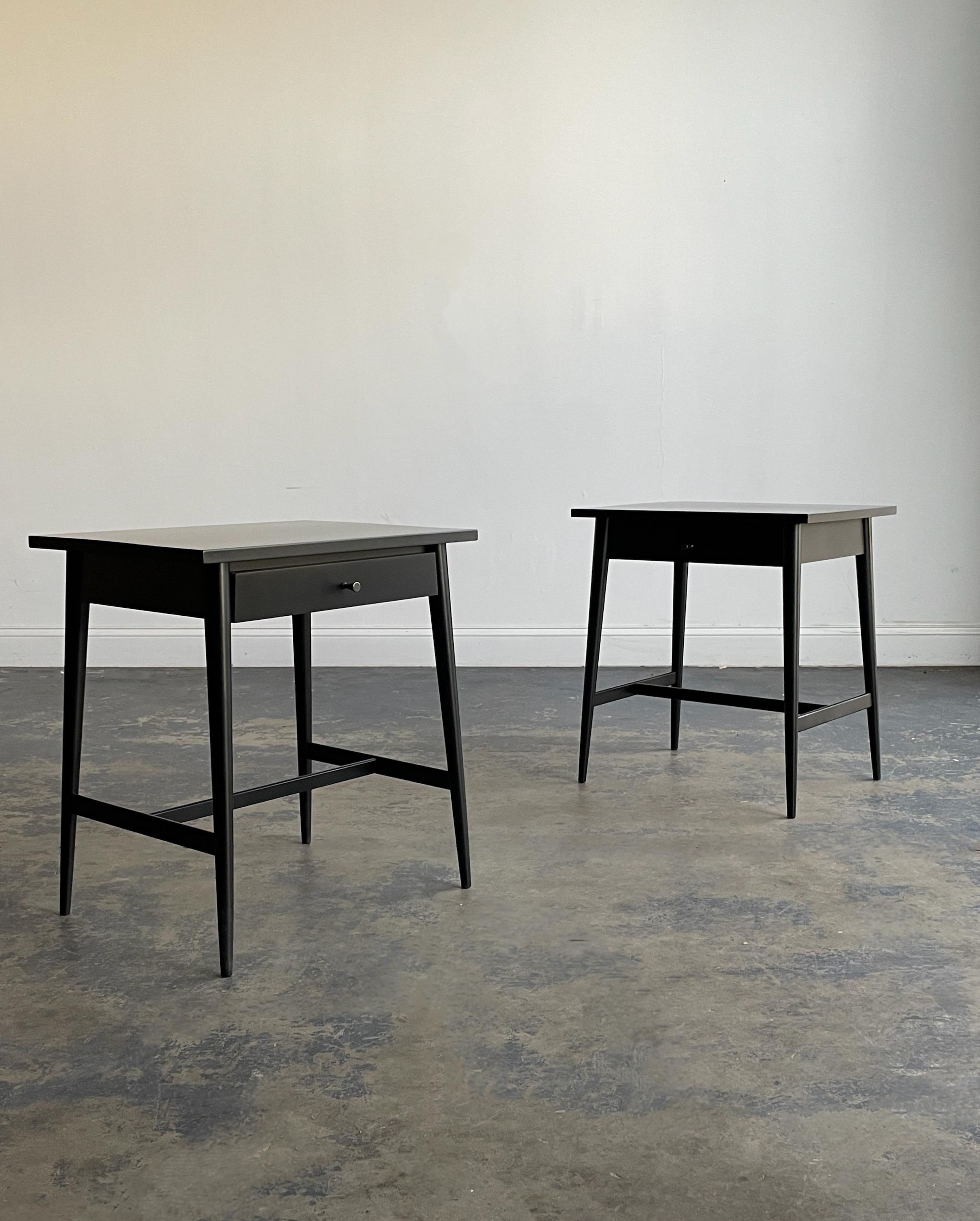 Pair of nightstands or end tables designed by Paul McCobb for his planner group line. Freshly ebonizedin a satin black finish. Drawer pulls have been cleaned as well. Some wear to interior of drawers.