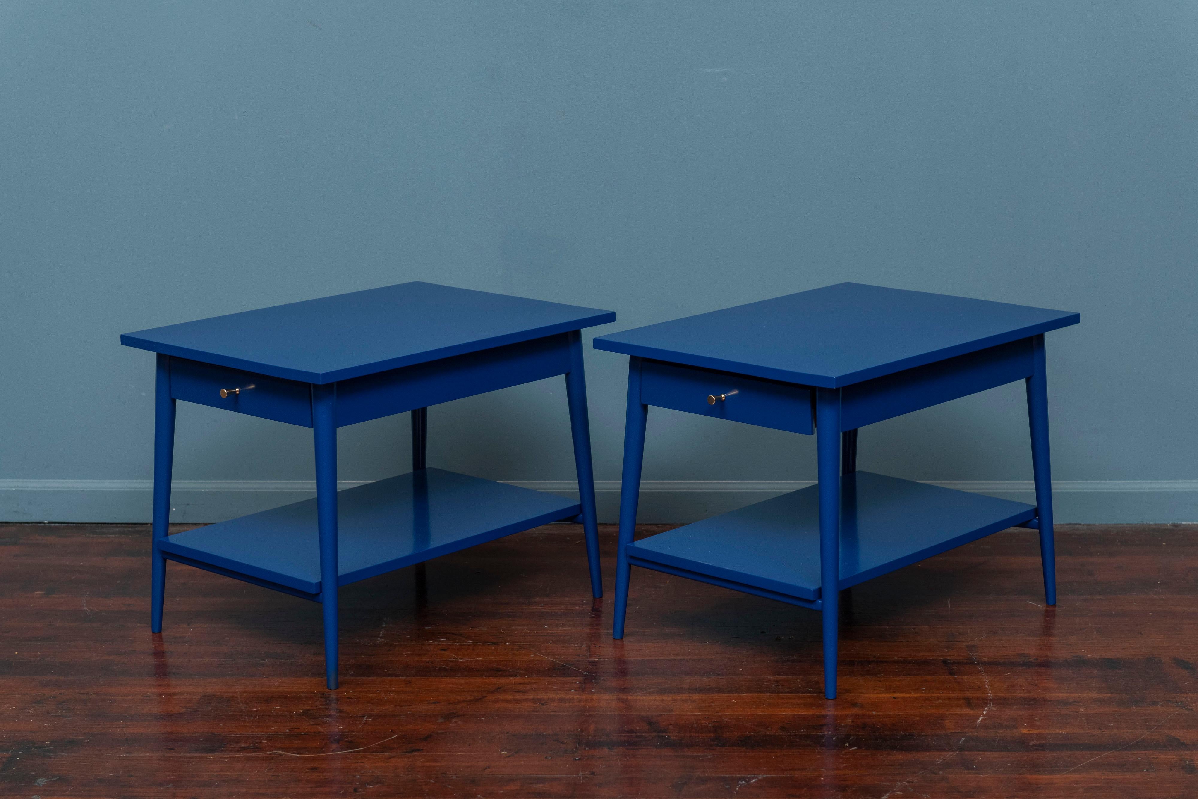 Paul McCobb design Planner Group end tables produced by Winchendon, MA. Simple, clean lines made from solid maple and newly refinished in a cobalt blue lacquer with polished brass dart pulls. Ready to install and enjoy!