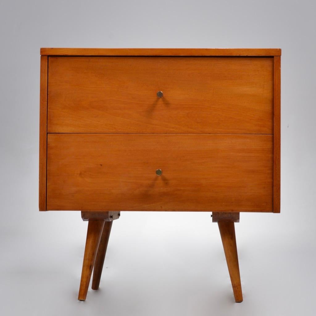 Classic Mid-Century Modern nightstand designed by Paul McCobb for his Planner Group line for Winchendon Furniture. The nightstand features solid maple construction, with gorgeous wood grain and sleek, minimalist design. It offers a great amount of