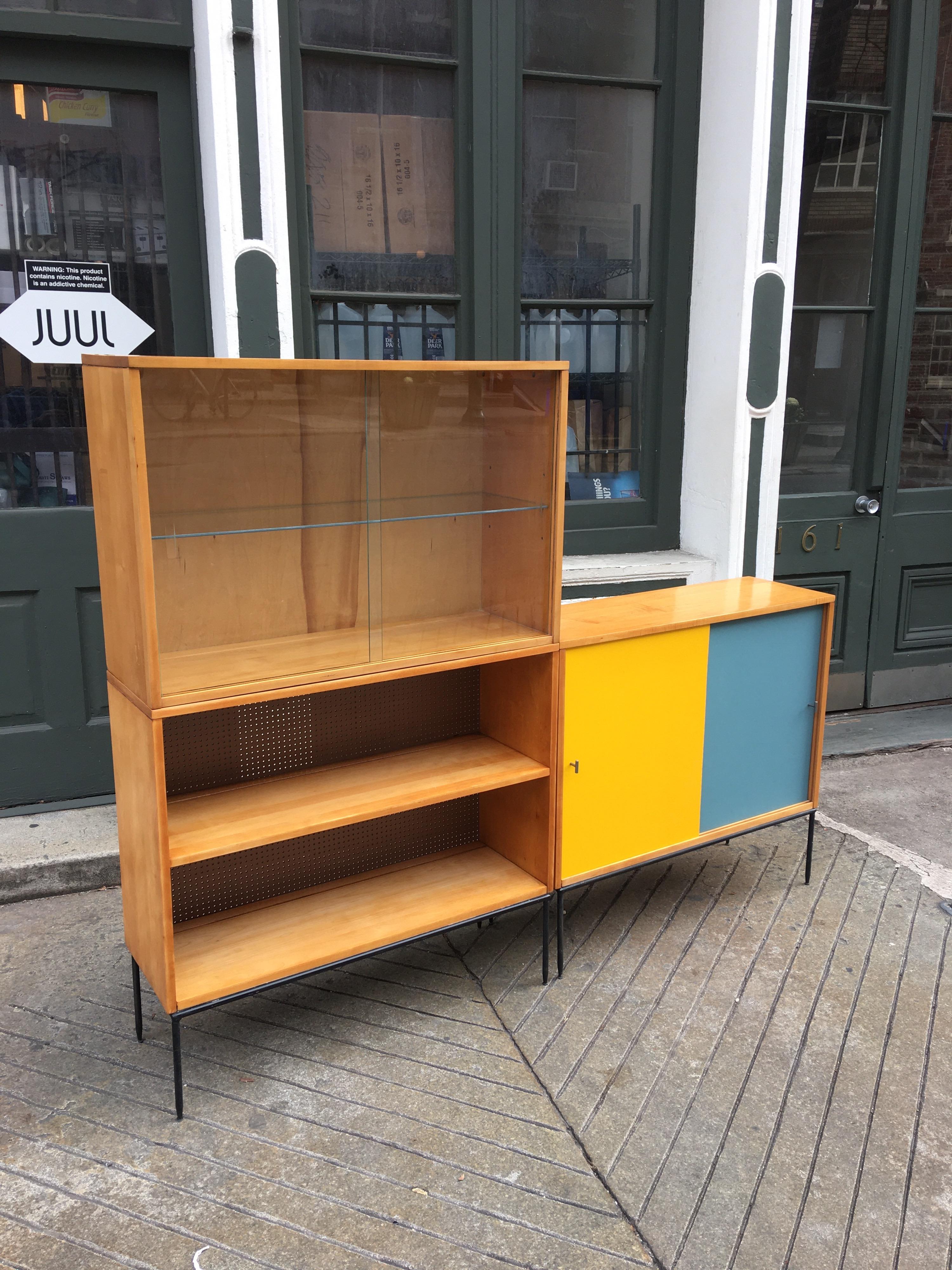 Paul McCobb 3 Piece Bookcase comprised of one cabinet with masonite sliding doors, one cabinet with glass sliding doors and glass shelf and one open unit with fixed shelf. Doors have been recovered with a period covering much like original. Can be