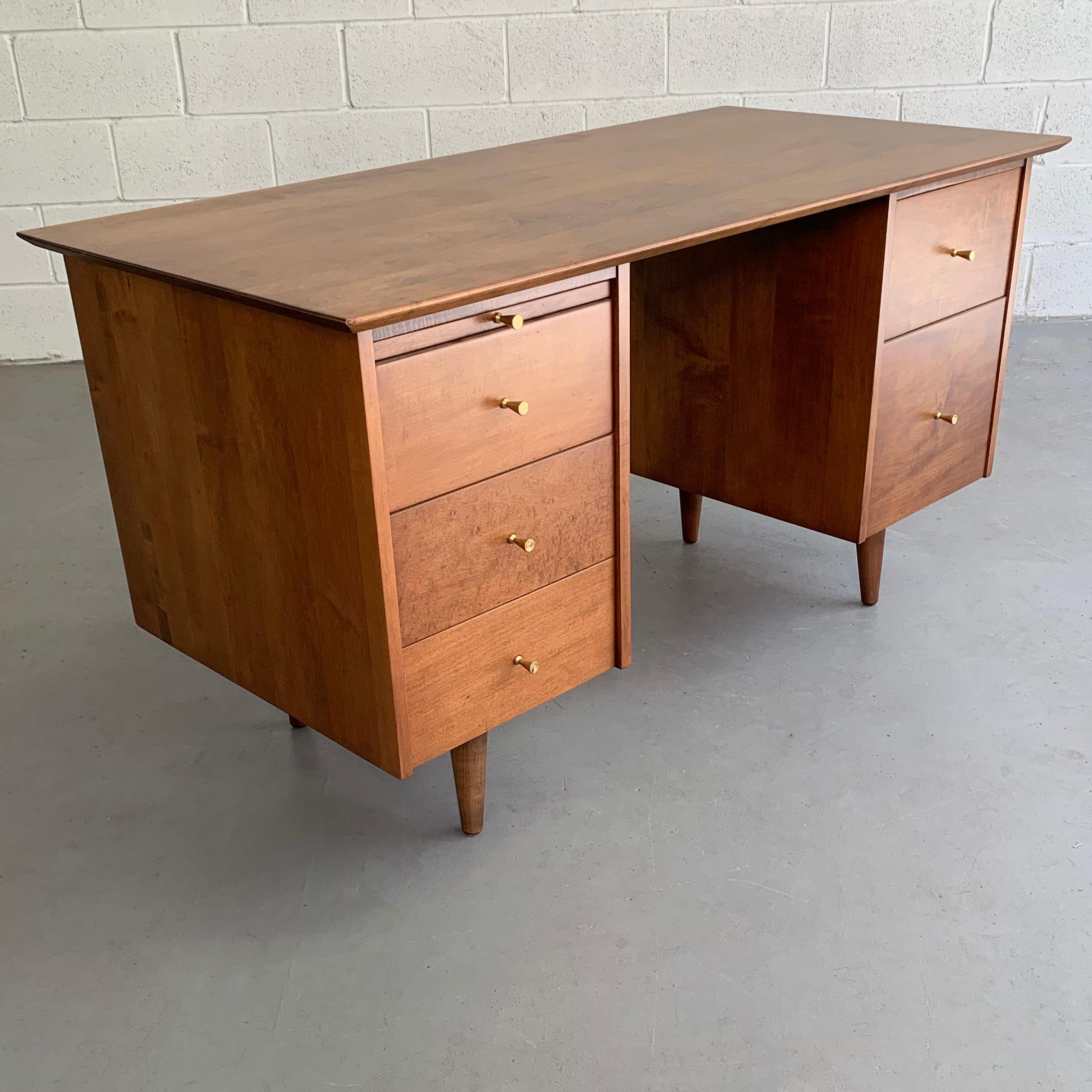 Mid-Century Modern, medium-tone, maple desk by Paul McCobb, Planner Group for Winchendon features drawers on both sides and pullout / pull-out ledge with signature McCobb brass hourglass pulls.