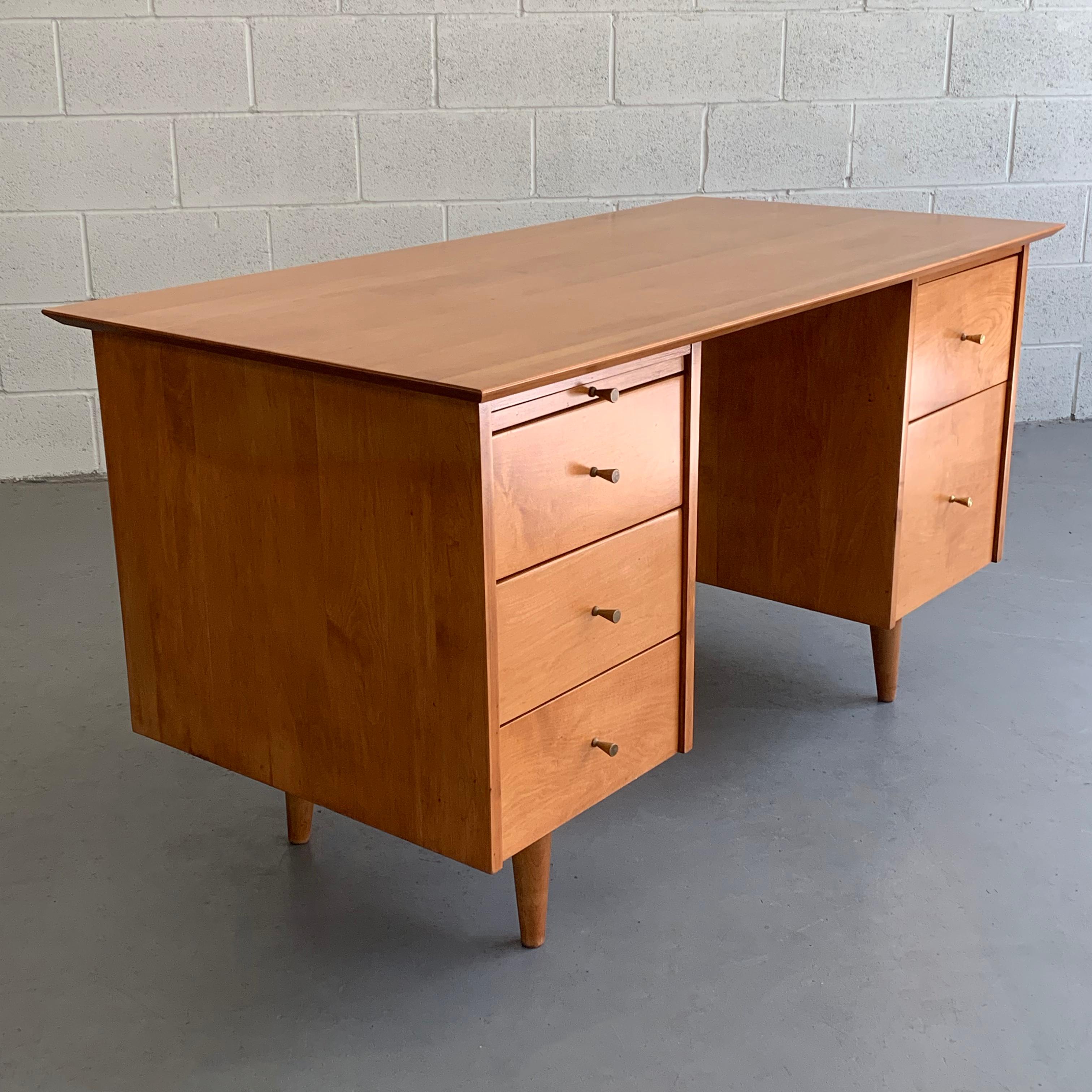 Mid-Century Modern, double pedestal, natural-tone, maple desk by Paul McCobb, Planner Group for Winchendon features drawers on both sides and pullout / pull-out ledge with signature McCobb brass hourglass pulls.