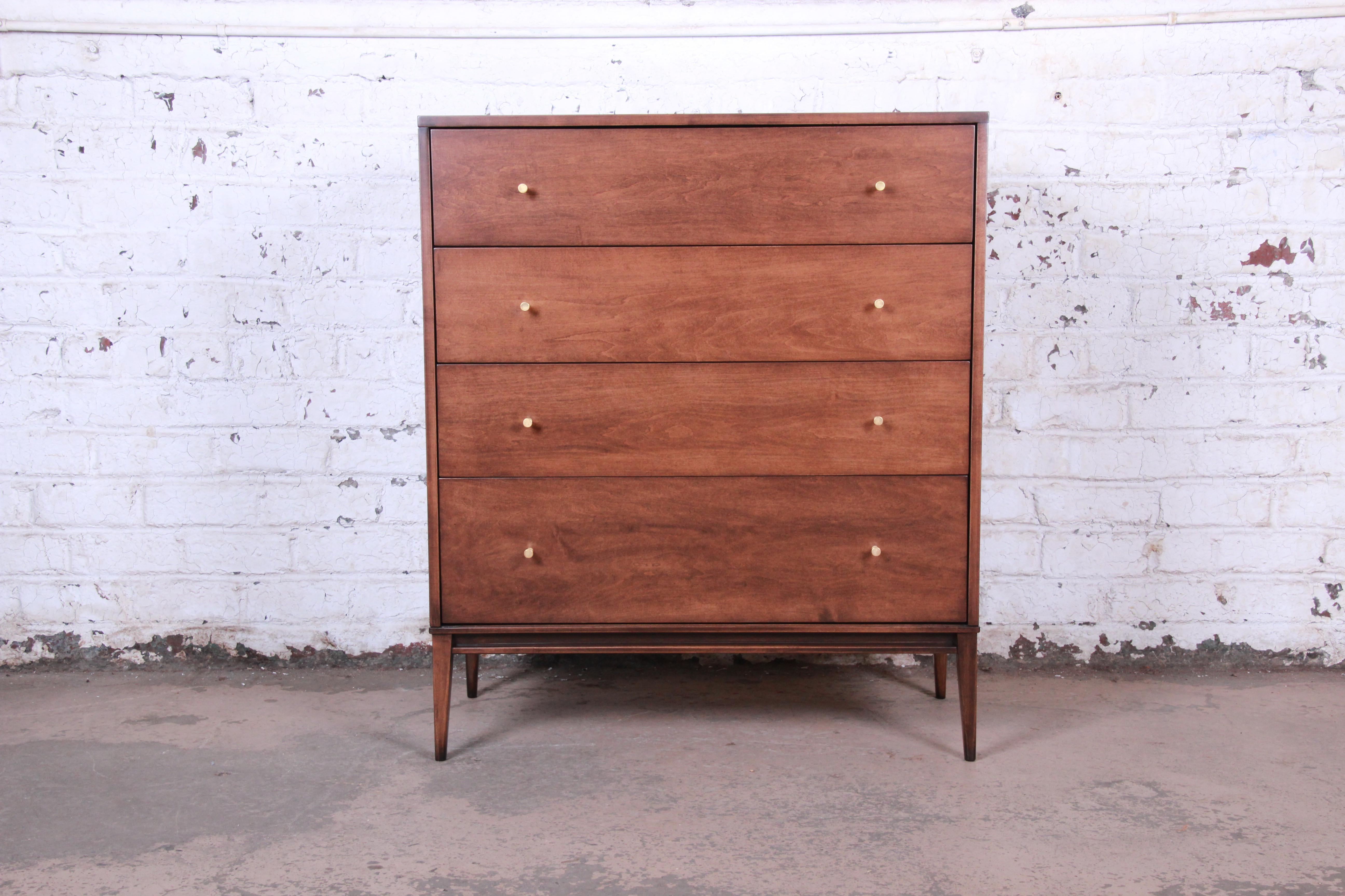 An exceptional mid-century modern highboy dresser designed by Paul McCobb for his Planner Group line for Winchendon Furniture. The dresser features solid birch wood construction and McCobb's iconic minimalist mid-century design. It offers ample room