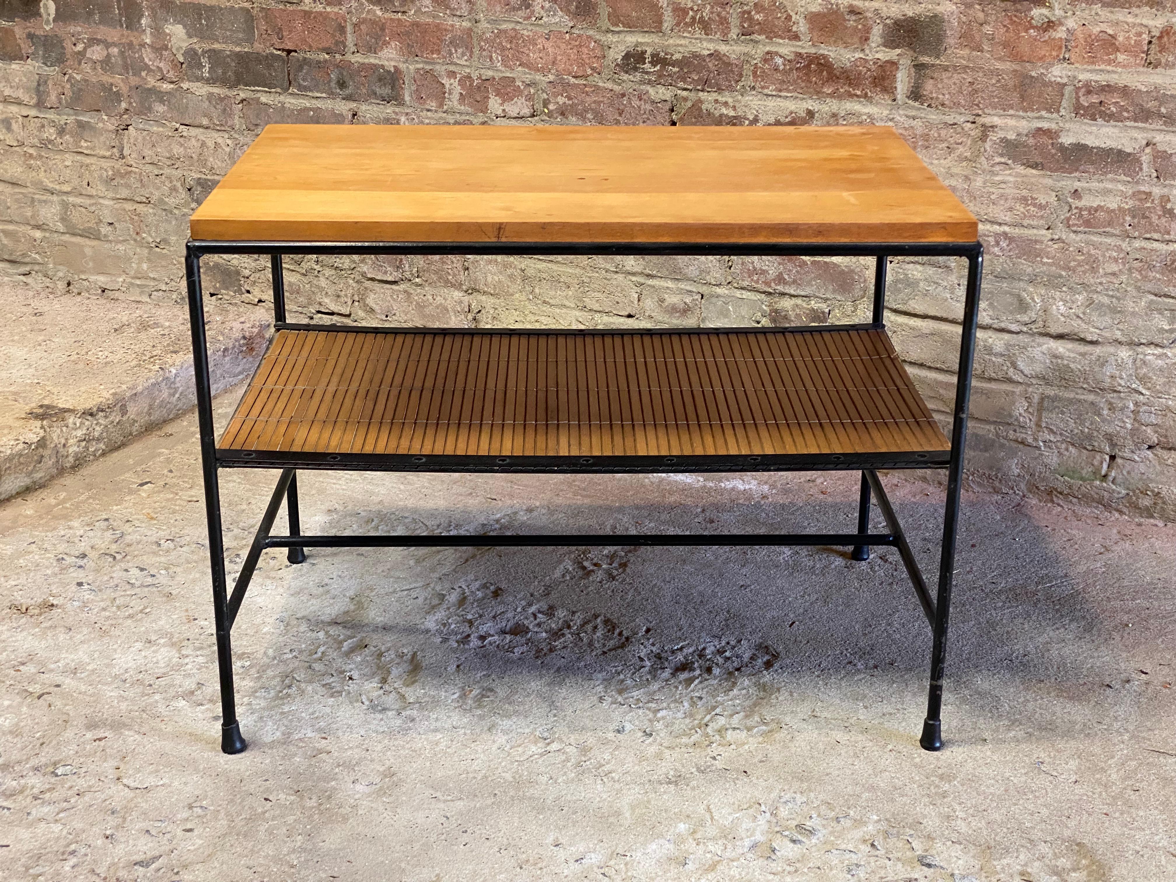 Pair of Planner Group side table designed by Paul McCobb for Winchendon. Circa 1955. Featuring a birch top, iron frame and split reed lower shelf. Good overall honest wear and overall condition with minor scratches to the top. Two minor stains.