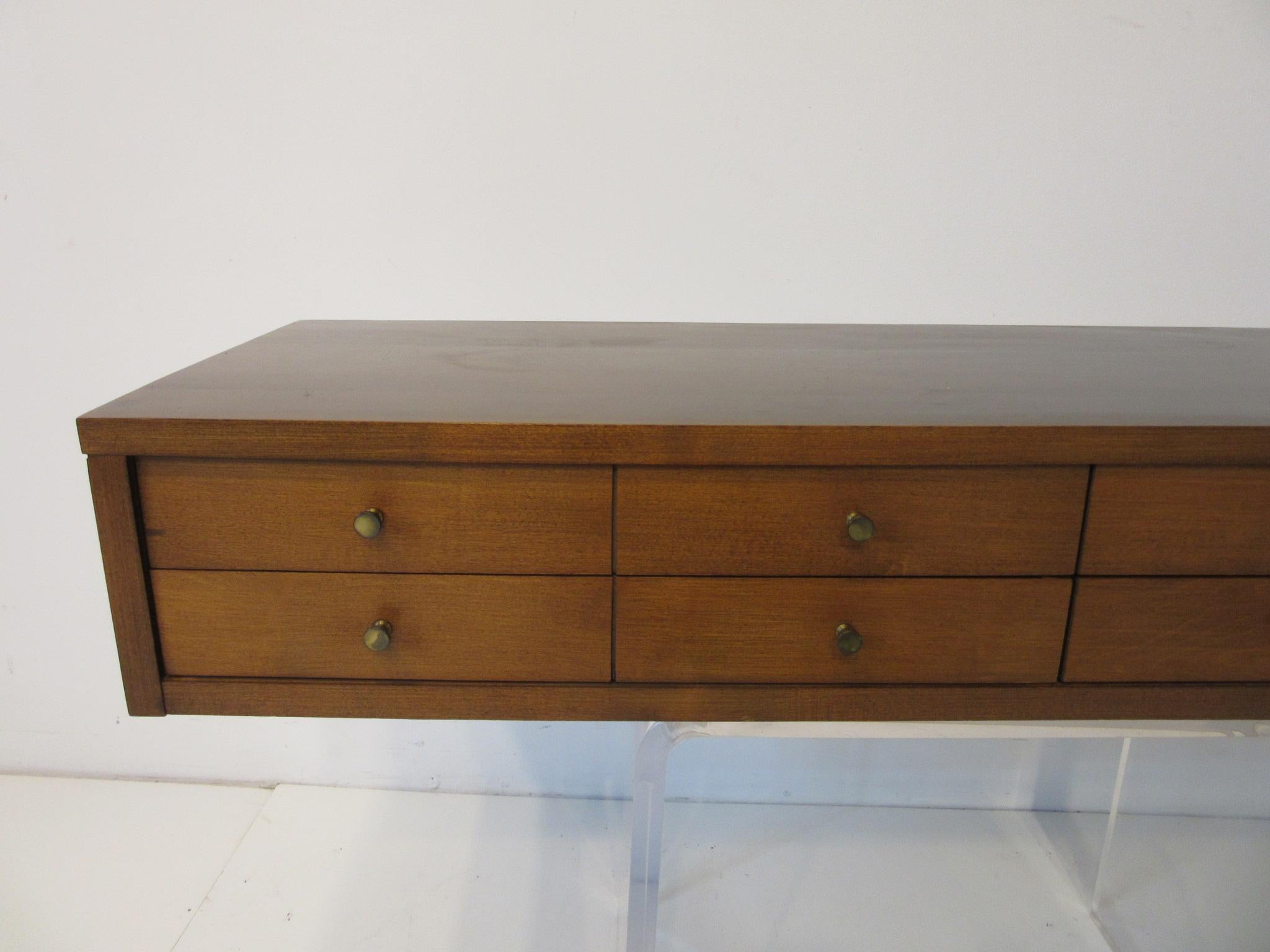 A solid maple jewelry / watch box chest in a medium dark toned tobacco finish with four drawers that are designed to look like a eight drawer chest. Smaller brass pulls to the front manufactured by the Winchendon Furniture Company from their Planner