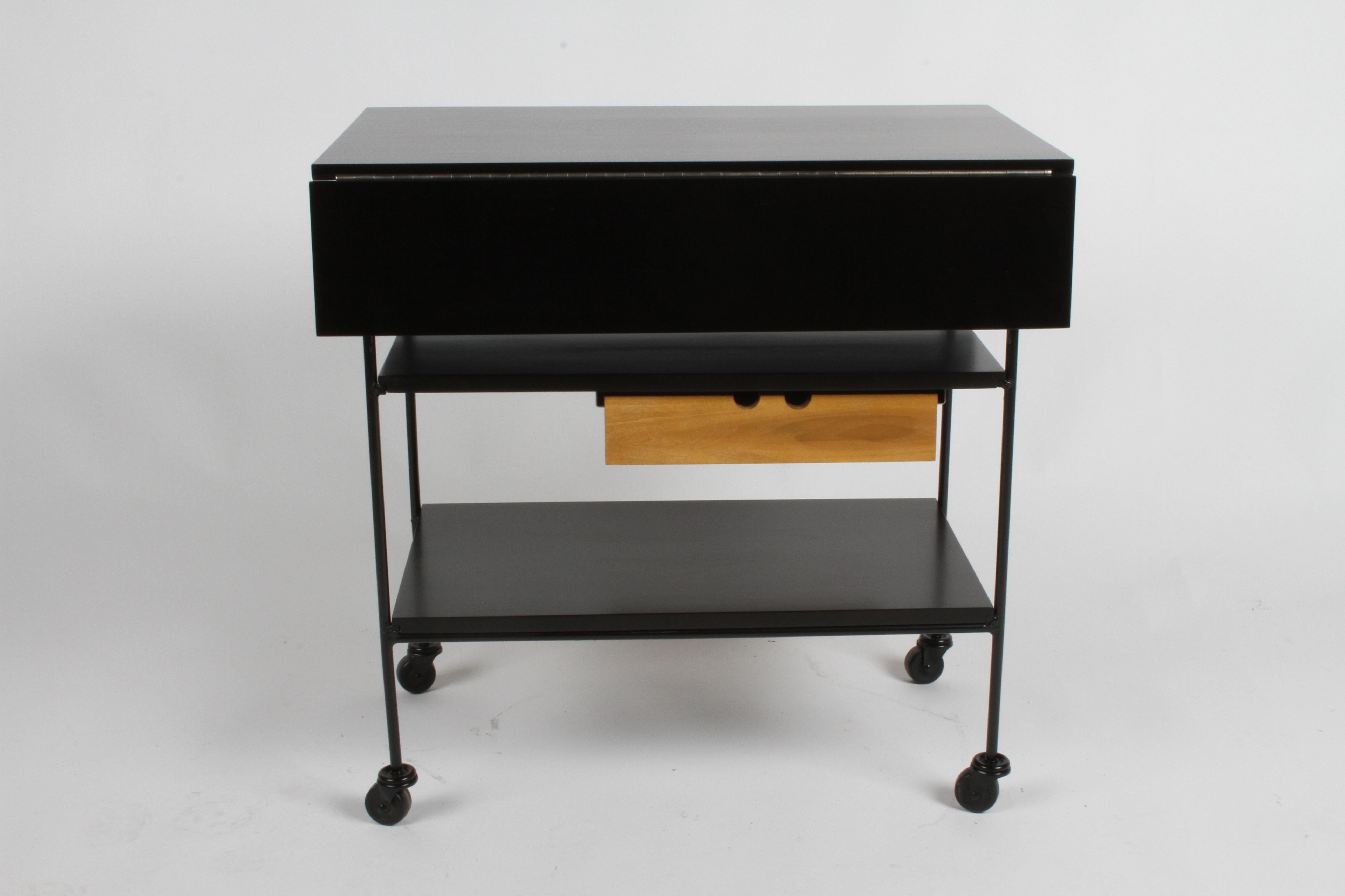 Mid-Century Modern Paul McCobb Planner Group black stained maple bar cart, painted black iron frame with expandable top, shelves and single drawer in natural maple. Each leaf is 6