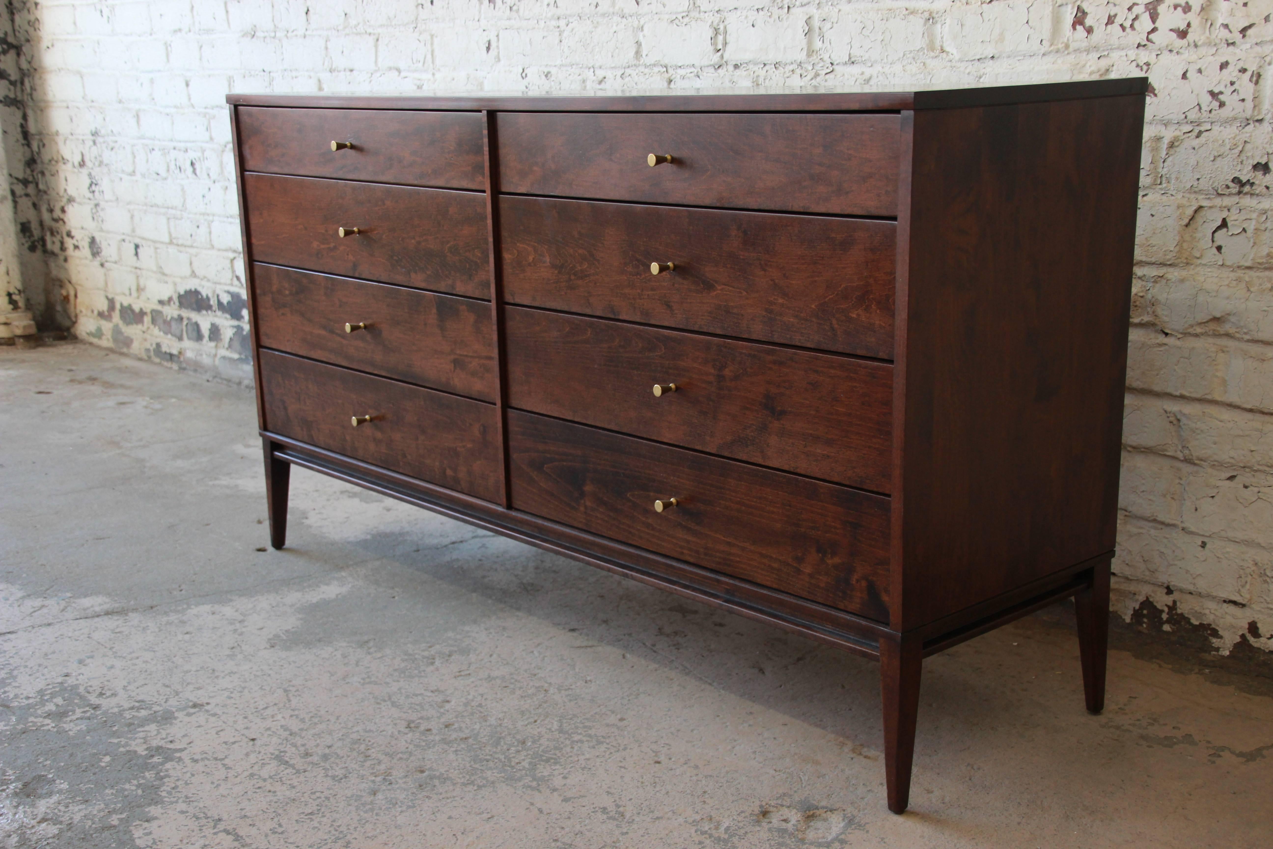 An outstanding Mid-Century Modern eight-drawer dresser or credenza designed by Paul McCobb for his iconic Planner Group line for Winchendon Furniture. The dresser features exceptional solid birch wood construction, and a body raised on slim, tapered