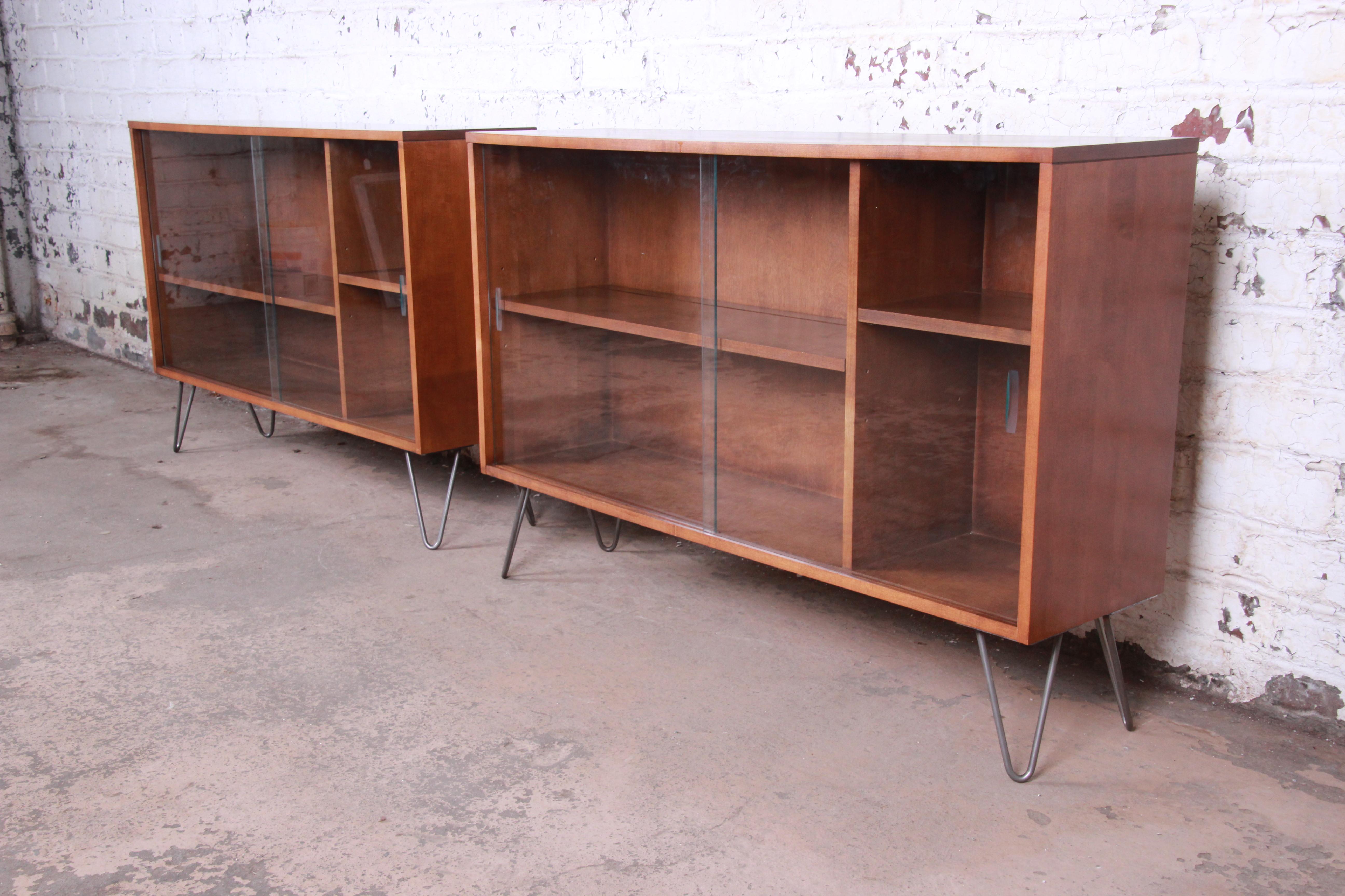 A sleek and stylish pair of Mid-Century Modern glass front credenzas or bookcases

Designed by Paul McCobb for Winchendon Furniture 