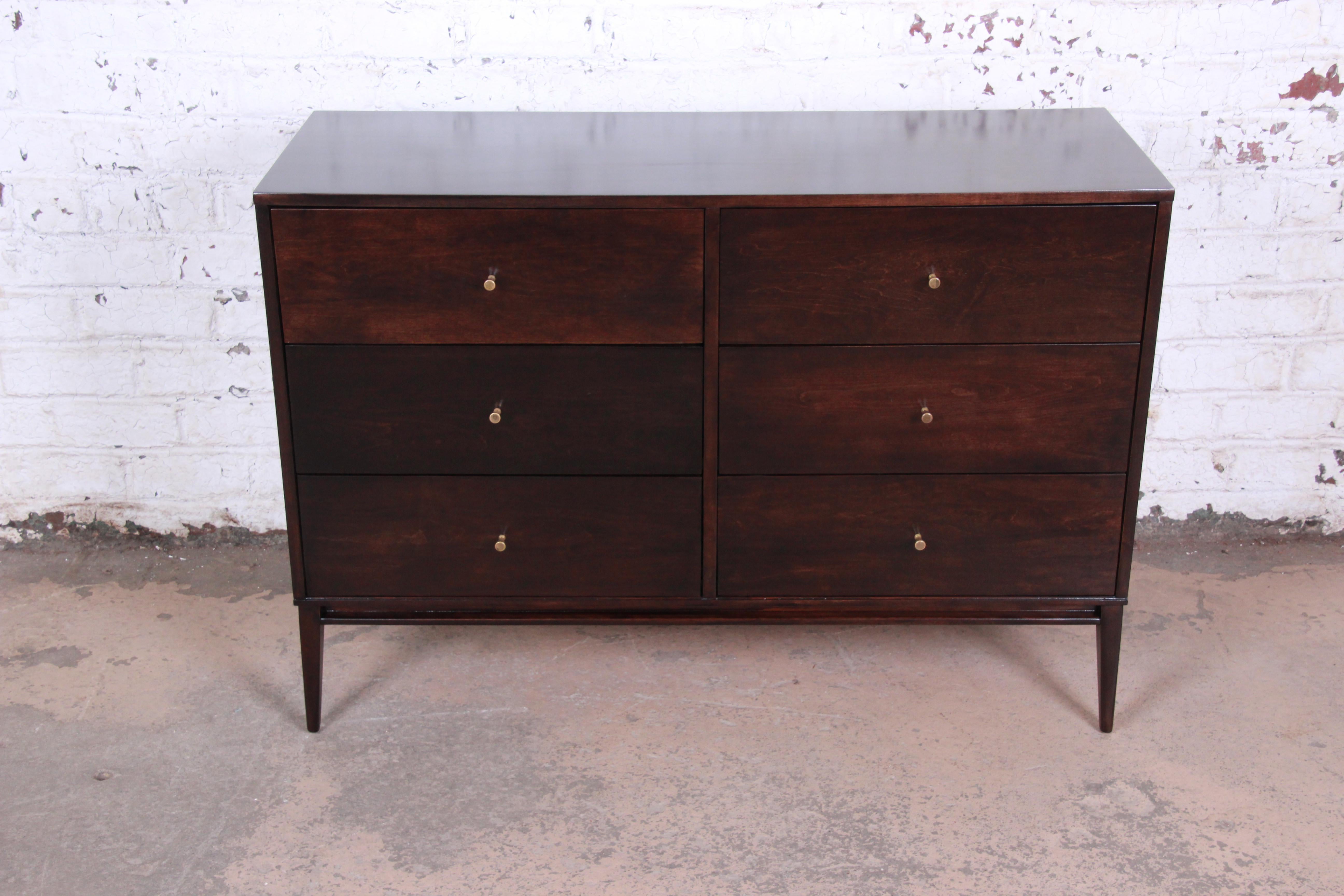 A stunning Mid-Century Modern six-drawer dresser designed by Paul McCobb for his Planner Group line for Winchendon Furniture. The dresser features solid birch wood construction and McCobb's iconic Minimalist midcentury design. It offers ample room