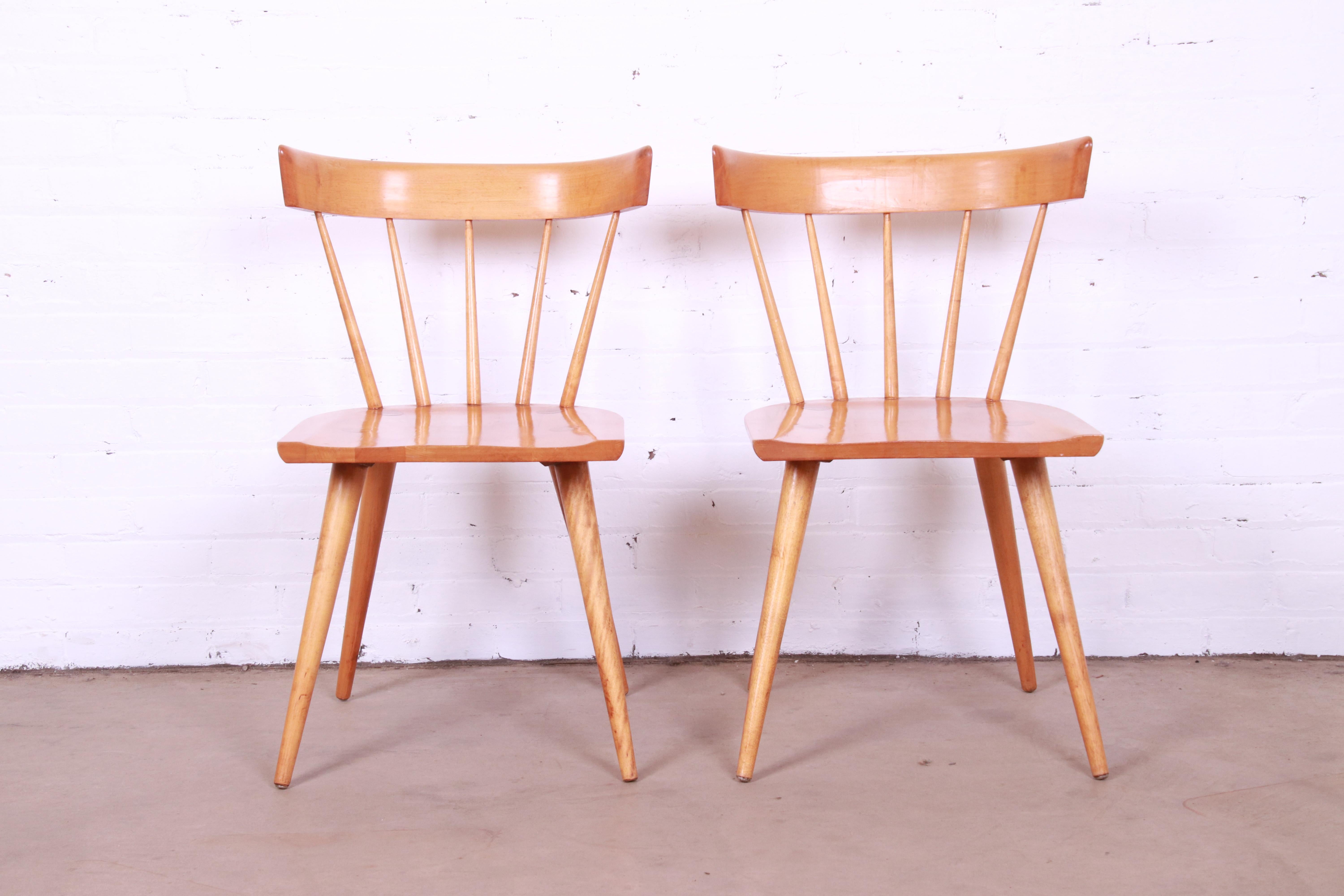 An exceptional pair of iconic mid-century modern solid maple spindle back dining chairs

By Paul McCobb for Winchendon Furniture, 