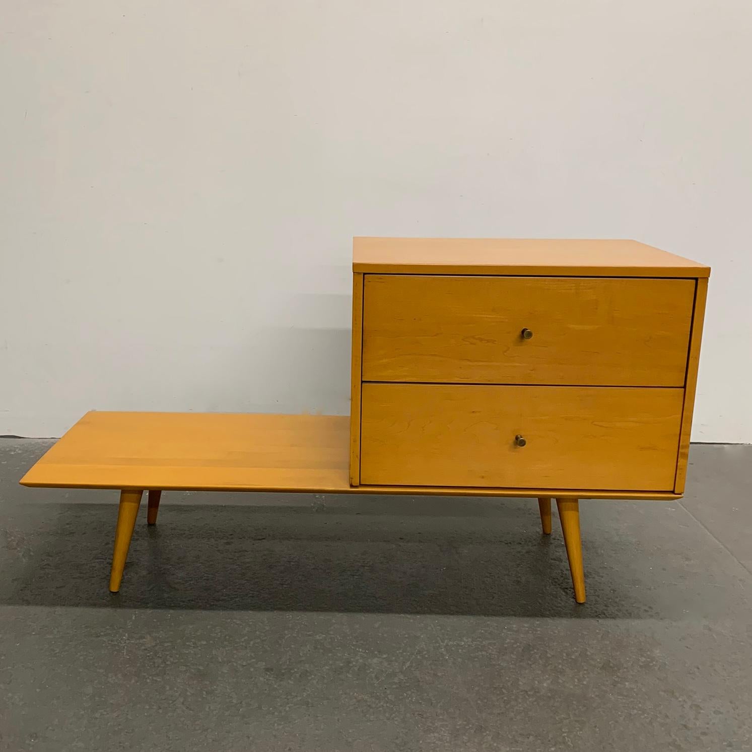 Mid-Century Modern, 2 piece, modular, maple unit by Paul McCobb Planner Group Winchendon features a 2-drawer dresser with brass hourglass pulls on a 10 inch high platform that can be used as a bench or side table. The dresser is 24 inches wide with