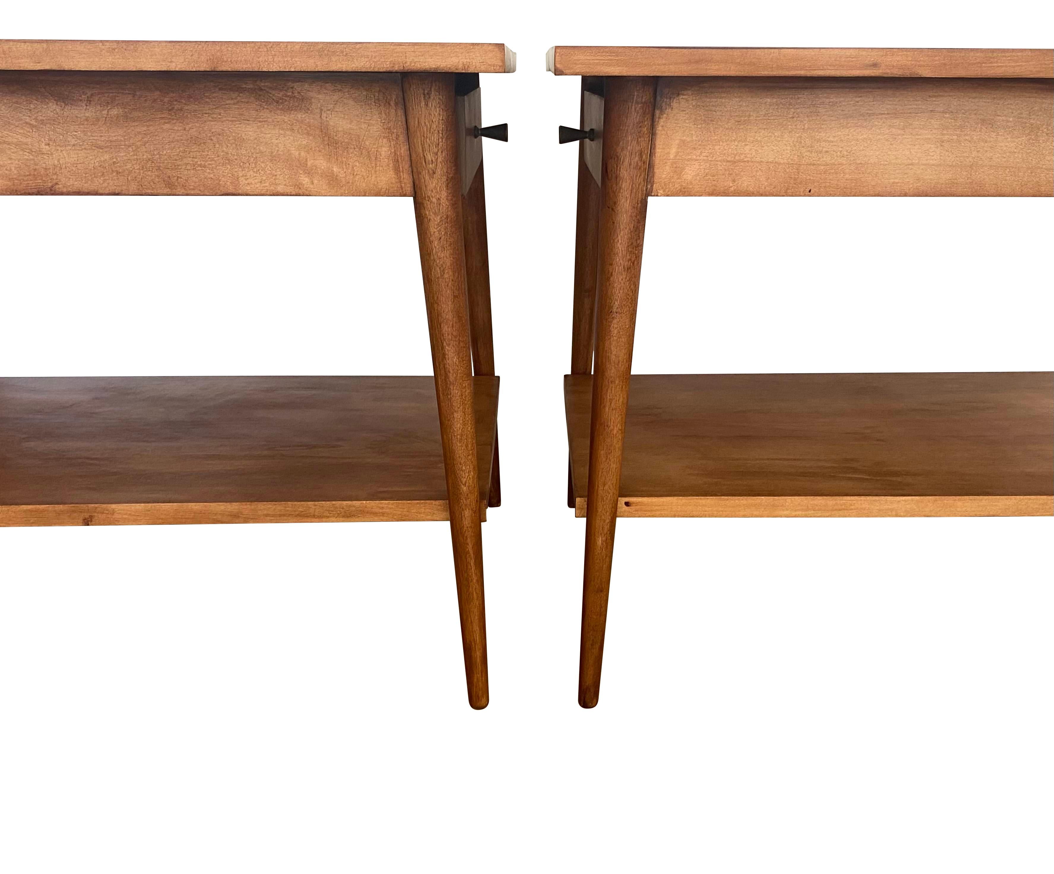 Handsome and elegant pair of nightstands designed by Paul McCobb. Part of the Planner Group collection and manufactured by Winchendon Furniture Company. Refinished and looking sharp. Original pulls. Signed and guaranteed authentic. Drawers function