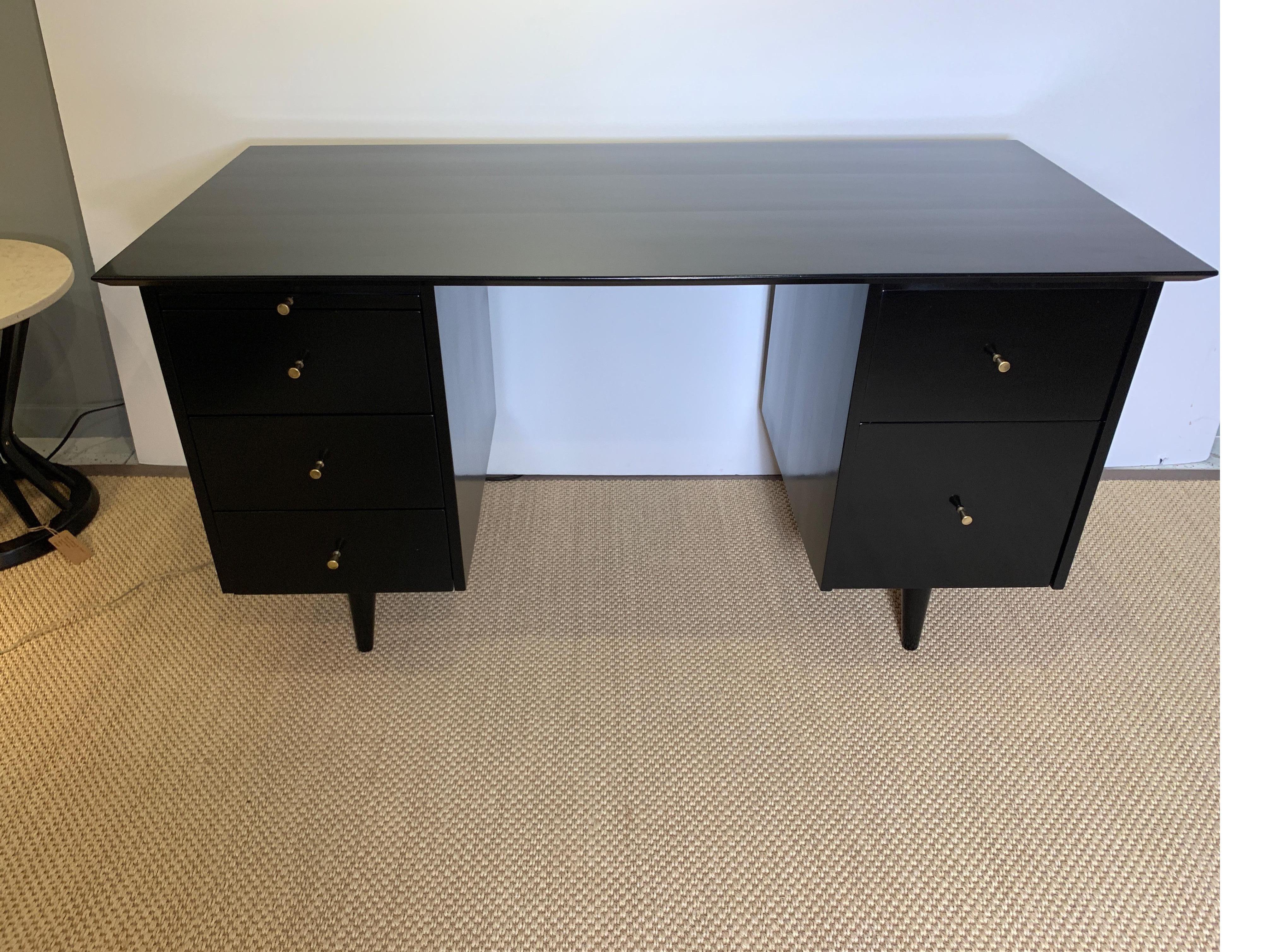 Stunning ebonized desk, finished on all sides allowing it to float in the middle of a room. Wonderfully refinished, and brass hardware has patinated to perfection.