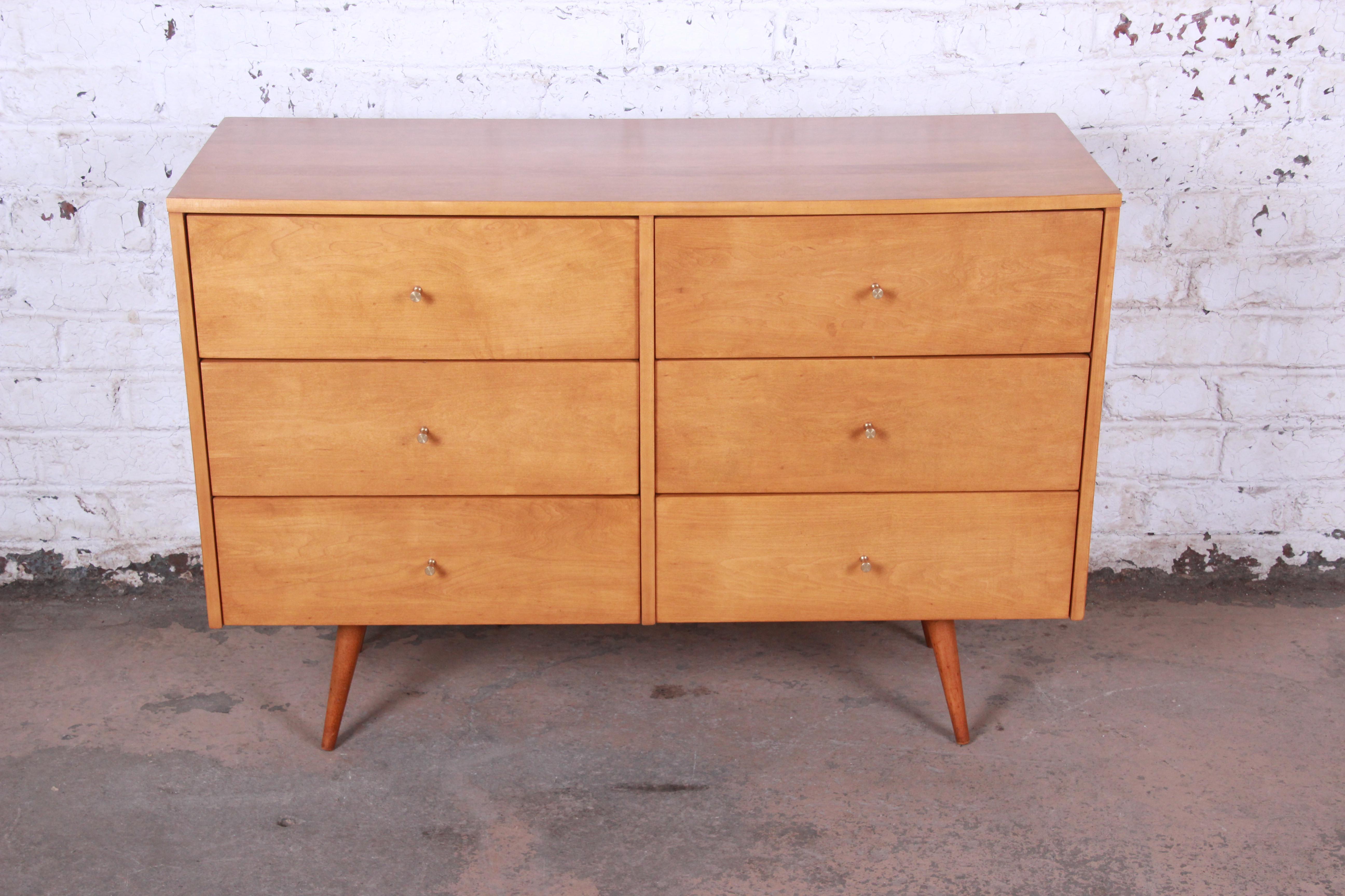 A stunning original Mid-Century Modern six-drawer dresser designed by Paul McCobb for his Planner Group line for Winchendon Furniture. The dresser features solid birch wood construction and McCobb's iconic Minimalist midcentury design. It offers