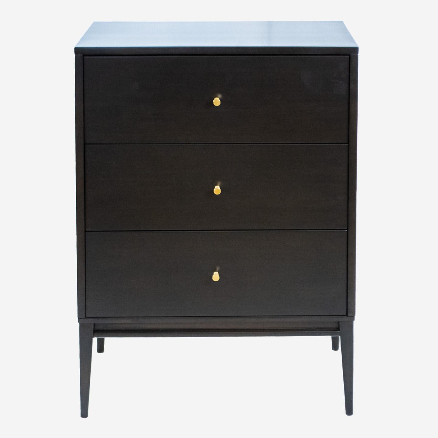 Designed by internationally known contemporary designer Paul McCobb, we offer this very special pair of tall night stands constructed in birchwood and lacquered in blackened brown. The design features stylish tapered legs and well executed