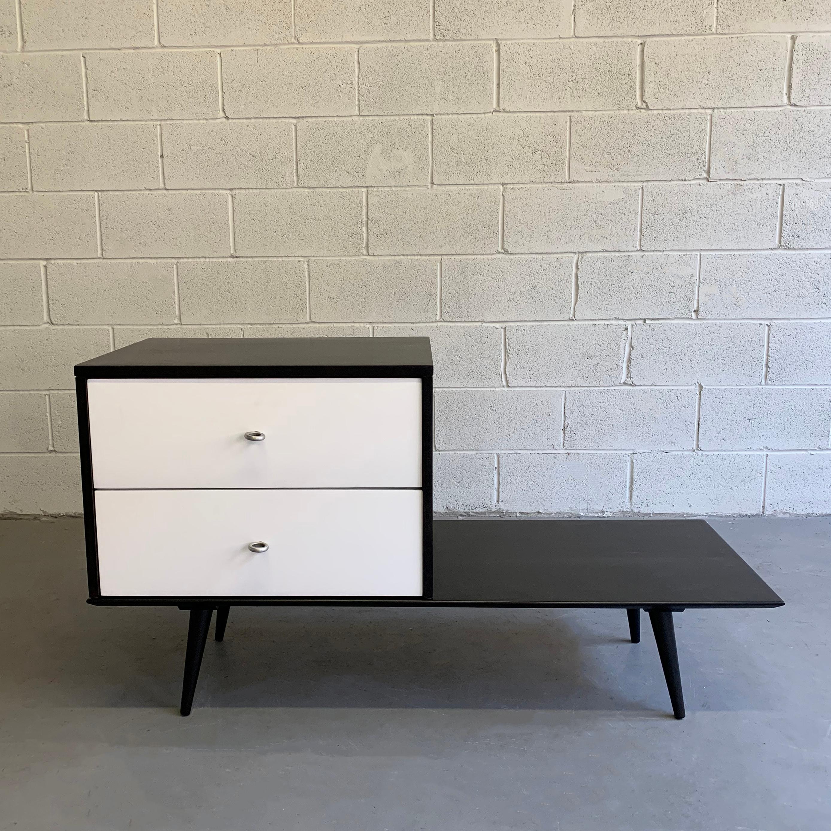 Mid-Century Modern, 2 piece, lacquered black and white, modular, maple dresser unit by Paul McCobb Planner Group Winchendon features a 2-drawer dresser with brass hourglass pulls on a 10 inch high platform that can be used as a bench or side table.