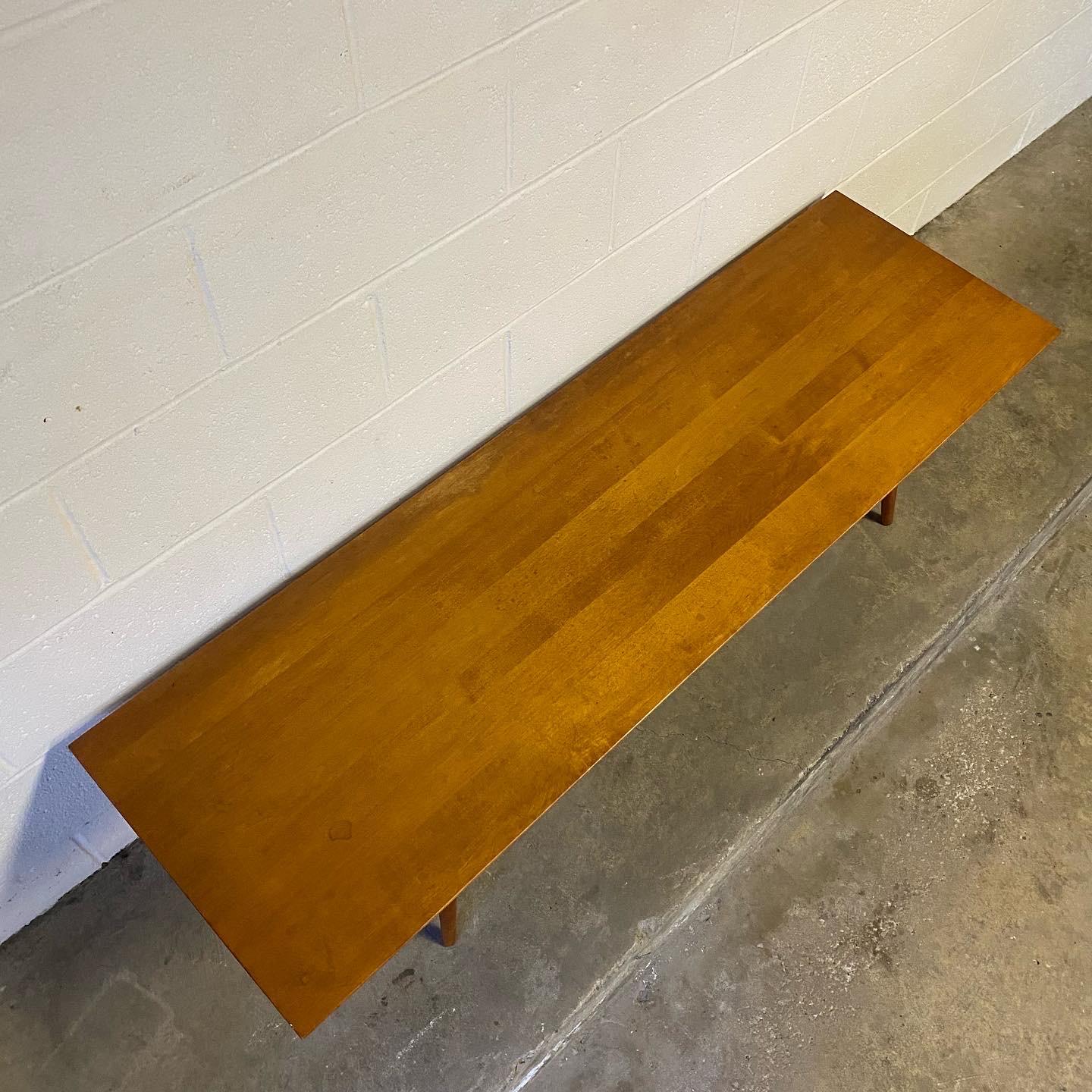 This is a nice vintage solid maple coffee table or bench designed by Paul McCobb for his Planner Group produced by Winchendon Furniture Co. in the 1950’s. This particular piece has the original tobacco finish, sort of a mix between light walnut and