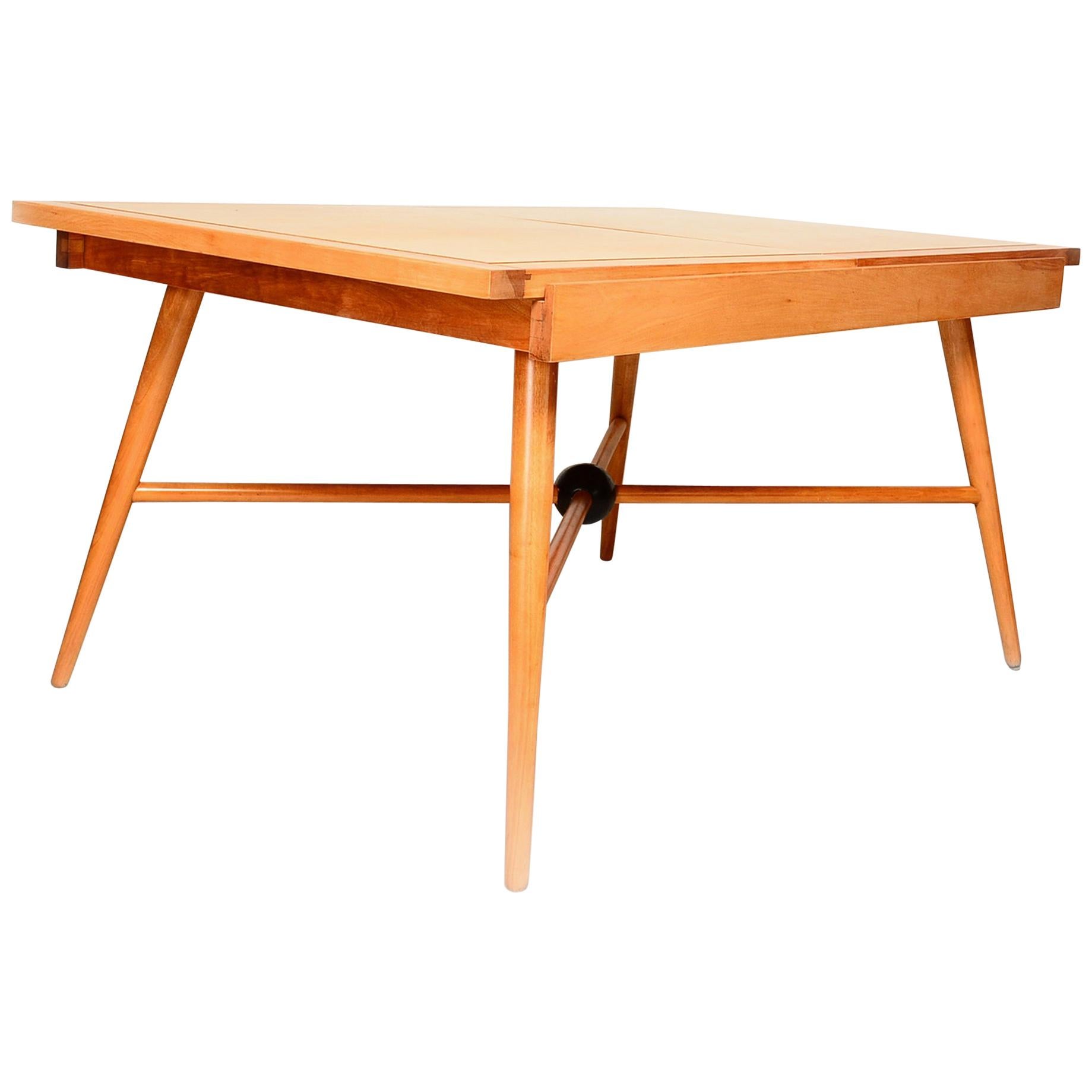 Pleasant Solid Maple Wood Dining Table with Built In Extension USA circa 1950s.
Design linked to Paul McCobb & Planner Group. Table presents with no visible stamp.
Dimensions: 29 in. H x 60 in. W x 39 in. D
Flared tapered legs skewed angle with