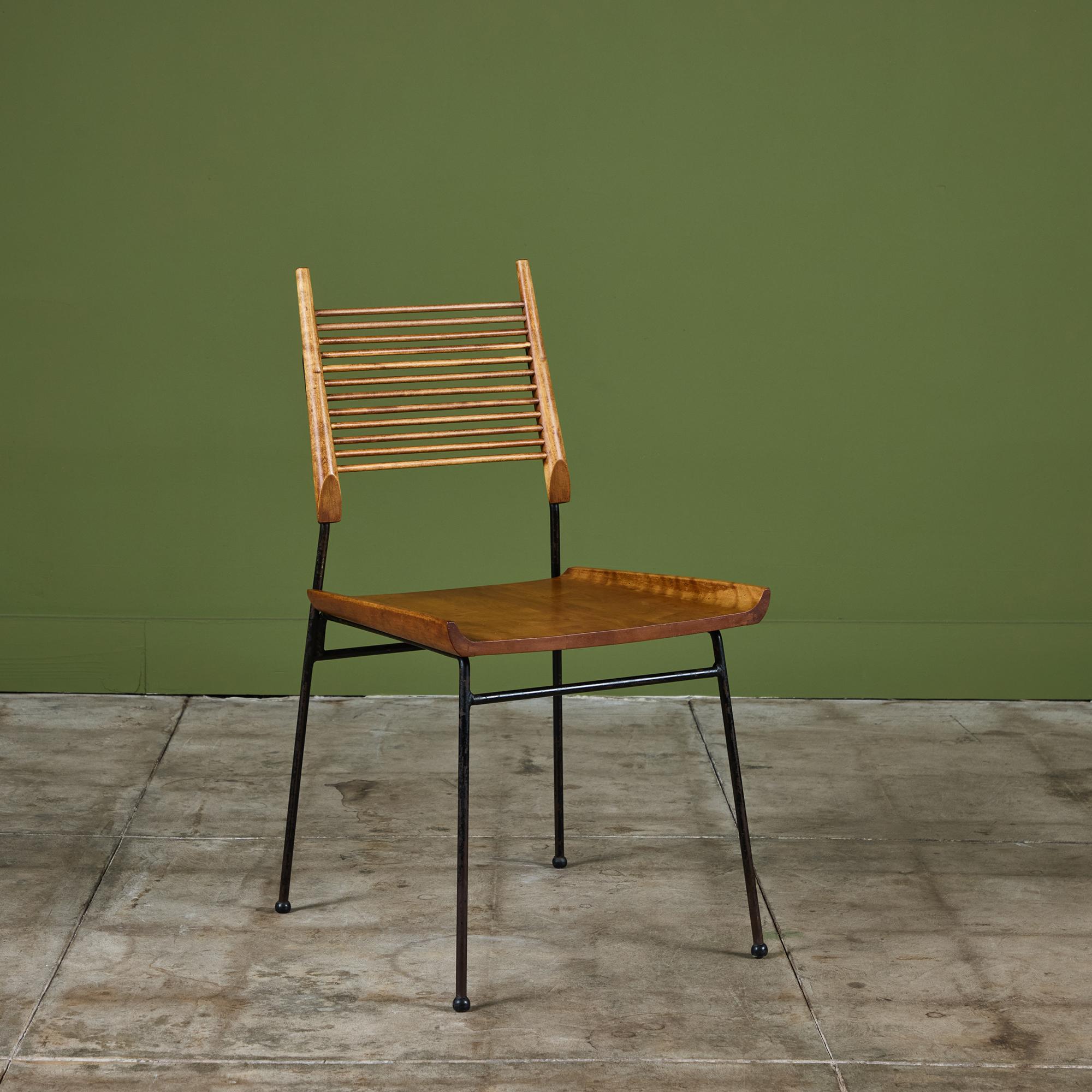 Shovel chair in maple and iron from Paul McCobb's iconic Planner Group, by Winchendon Furniture, c.1950s, USA. The chair features a spindle back rest and sculpted seat which is supported by an iron black powder coated frame.

Dimensions 
18” width x