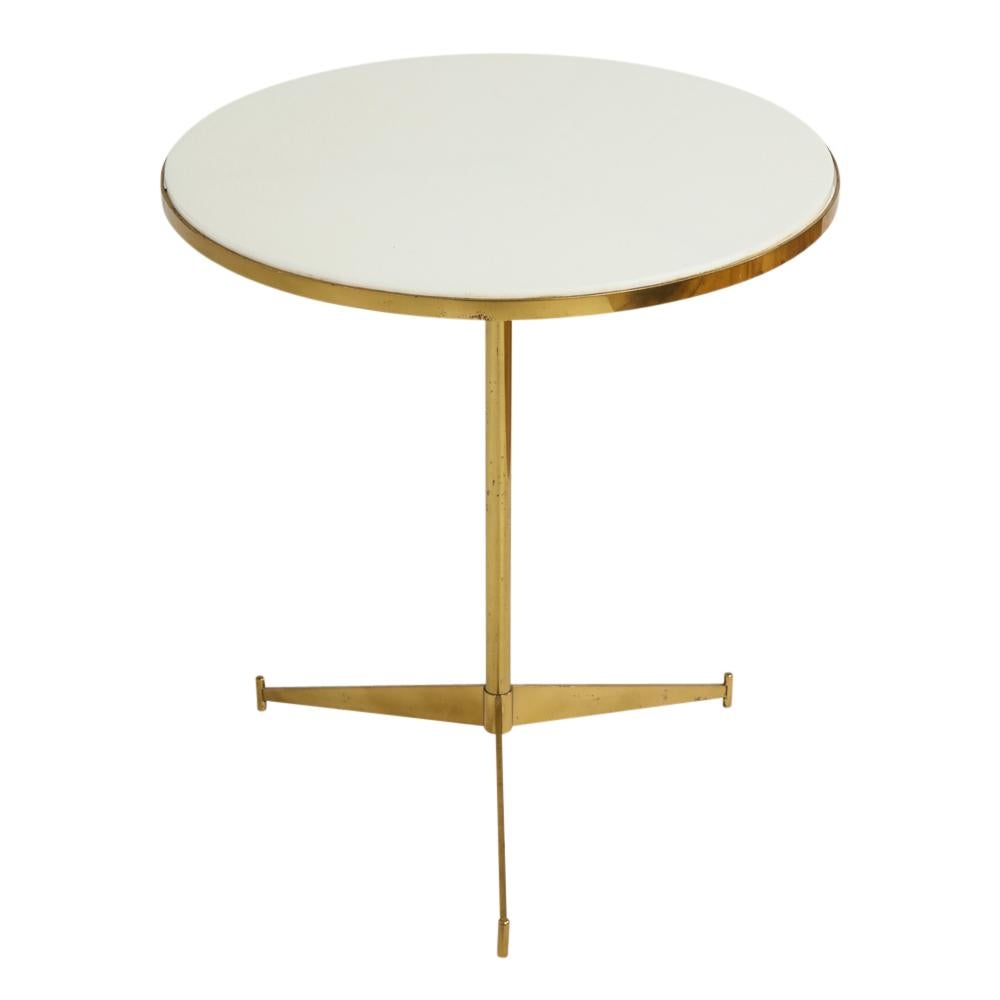 Paul McCobb side table, brass cigarette. A clean example of this classic table in good original condition having a lacquered brass frame and milky white glass Vitrolite top. First appeared in Directional Furniture Catalogue in 1954.