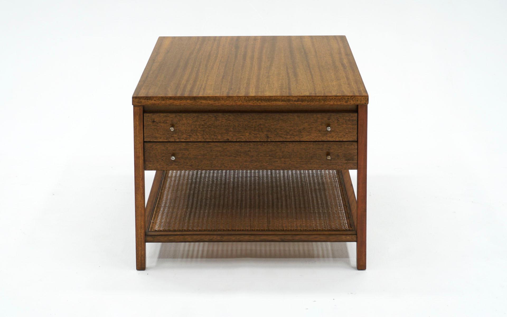 Night stand / side table / end table designed by Paul McCobb for Calvin. Almost square rectangle in a beautiful striped mahogany case with two drawers that function smoothly and lower shelf in cane. Retains the original pulls. No breaks or repairs
