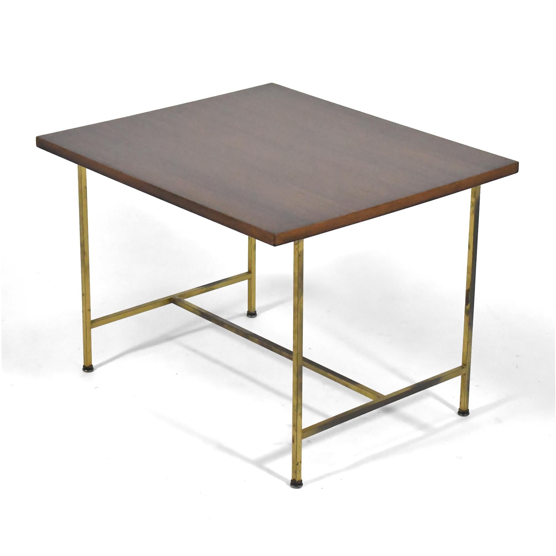 This exquisite vintage example of Paul McCobb's brass base table features a mahogany top and McCobb's elegant design in square stock brass. The table is entirely original and in very good condition with the most pleasing patina to the brass.

20.5