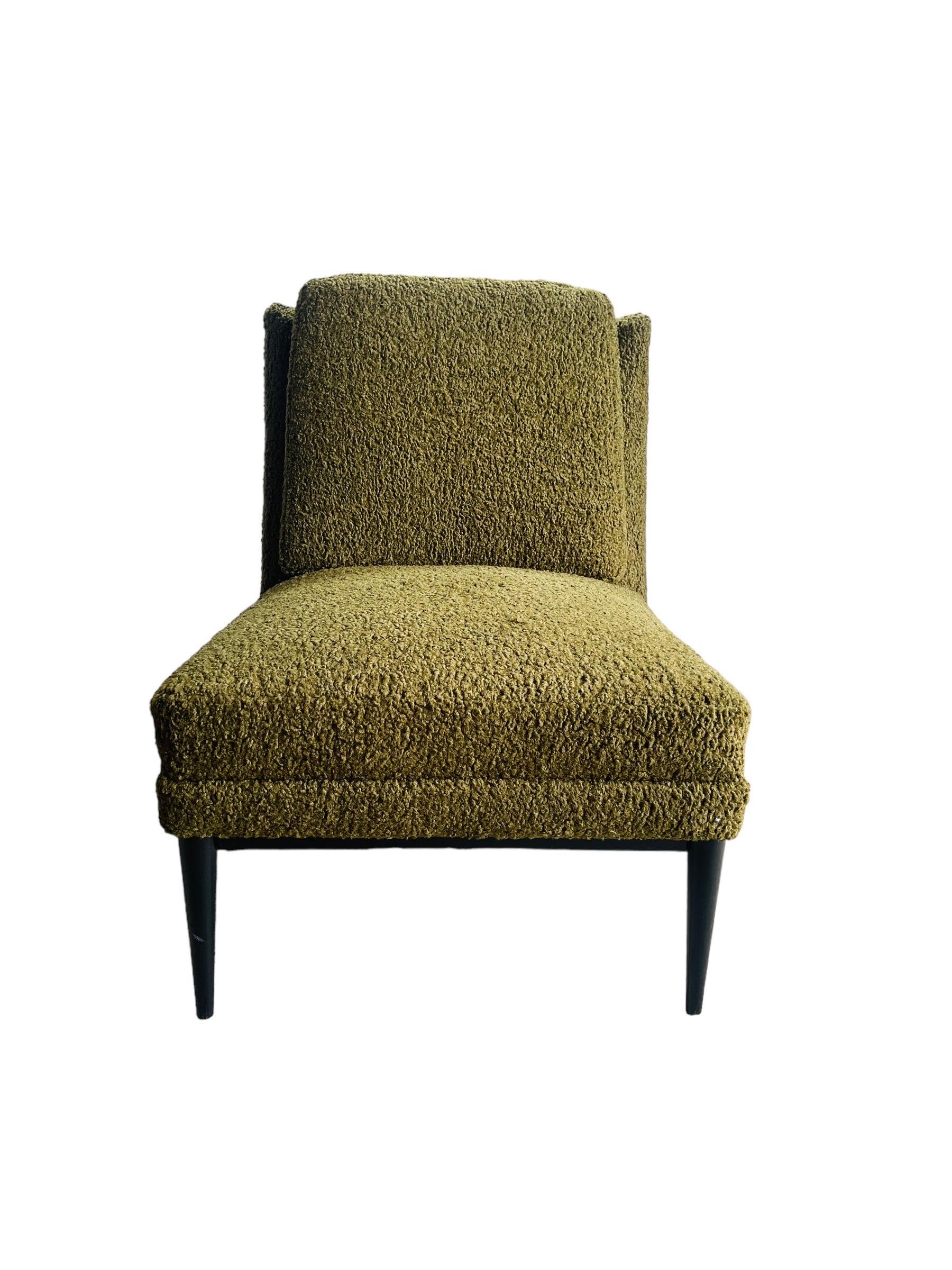 Dive into the sublime minimalism of the mid-century era with this exquisite slipper chair designed by the iconic Paul McCobb. Beautifully restored and reupholstered in a lush olive green bouclé fabric, this chair blends comfort with a clean, sleek